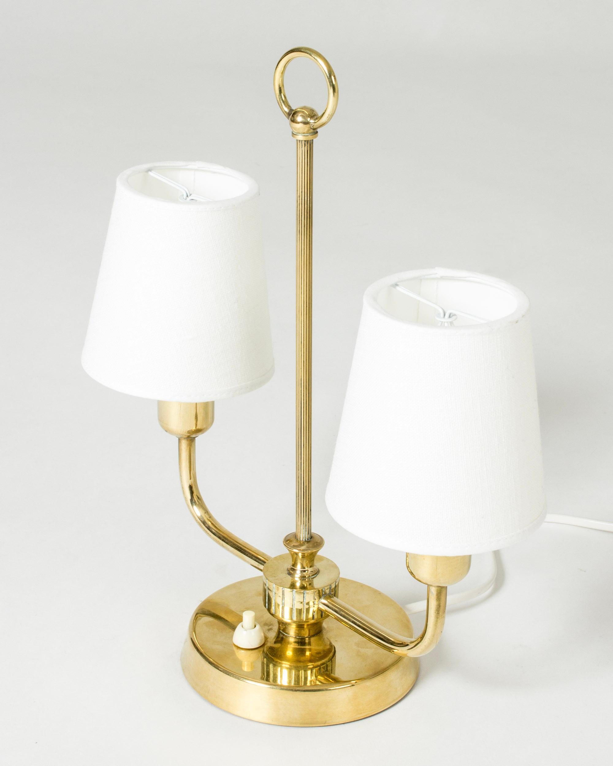 Lovely table lamp from Uppsala Armaturfabrik, made from brass. Neat size with decorative embossed stripes and a hoop at the top.