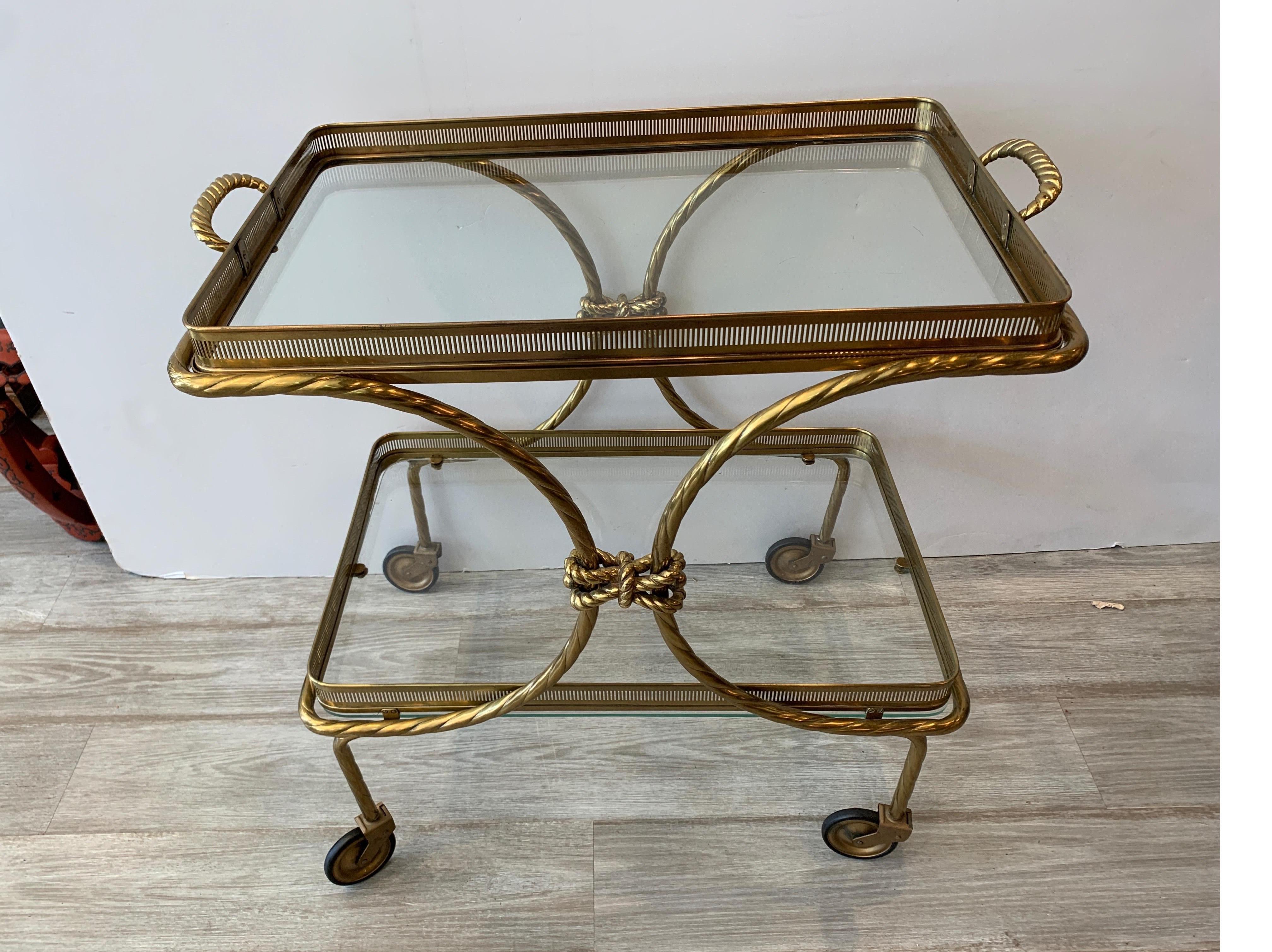 Midcentury brass tea cart with removable top tray with twist tassel design
Nice top tray that comes off to carry beverages to the table or guests
Dimensions: 27.25 H x 27' W x 17' D.
