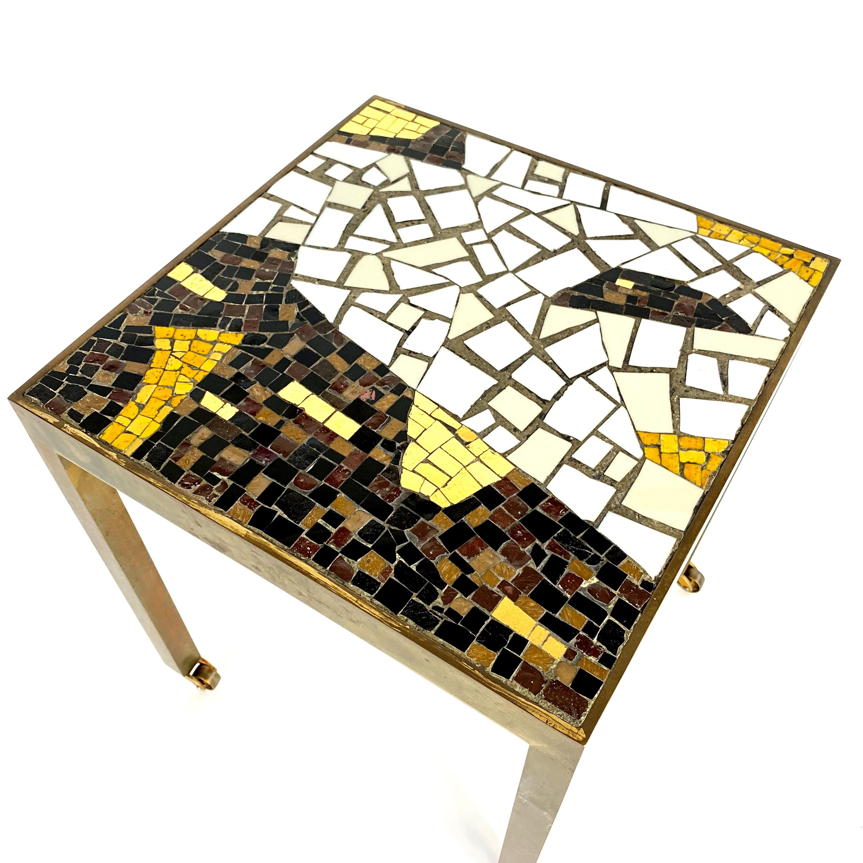Beautiful and authentic side table, manufactured in Italy in the 1950s. The frame is made of solid brass with Venetian mosaic glass and tile top. The table is in very good condition with nice patina on brass.
   
Measurement:
H 43 x L 39 x D 39
