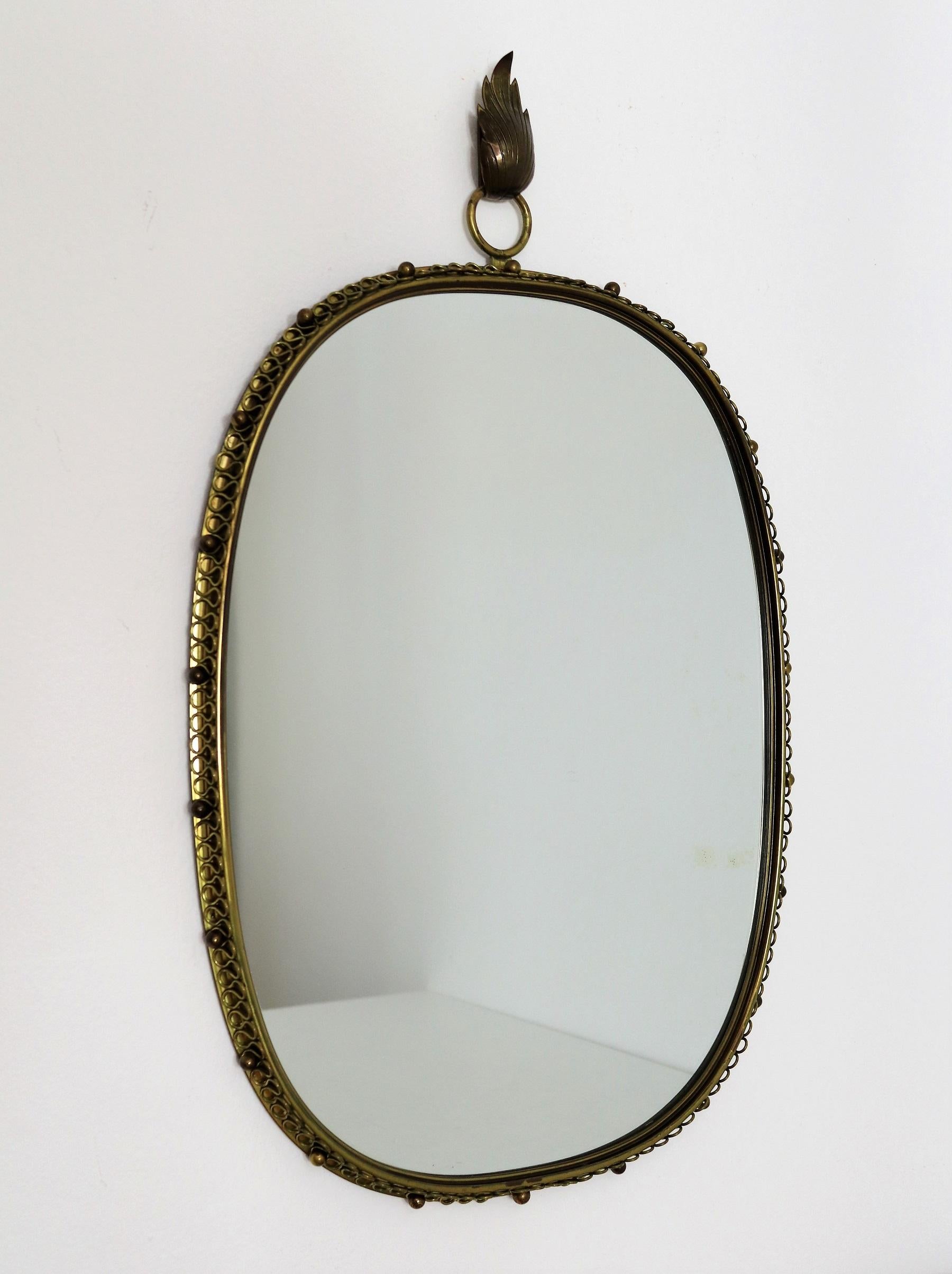 This is the original wall mirror designed by Austrian Josef Frank and manufactured in Sweden by Svensk Tenn in the mid-century.
This mirror is made of full brass frame with spiral loop frame around and big round hanging loop on top. With its