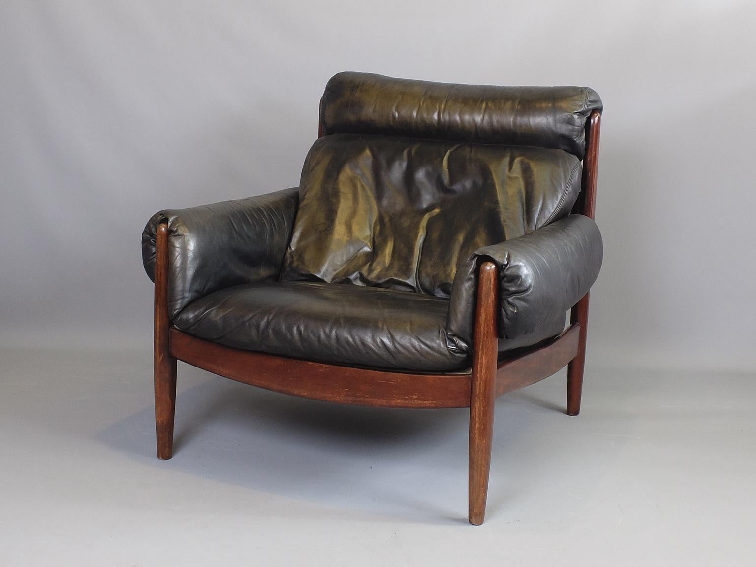 A midcentury mahogany framed armchair with original leather upholstery produced in Brazil, circa 1960. The chair is a generous size and very comfortable. The leather has a very attractive patina with signs of fading in places but is not worn or