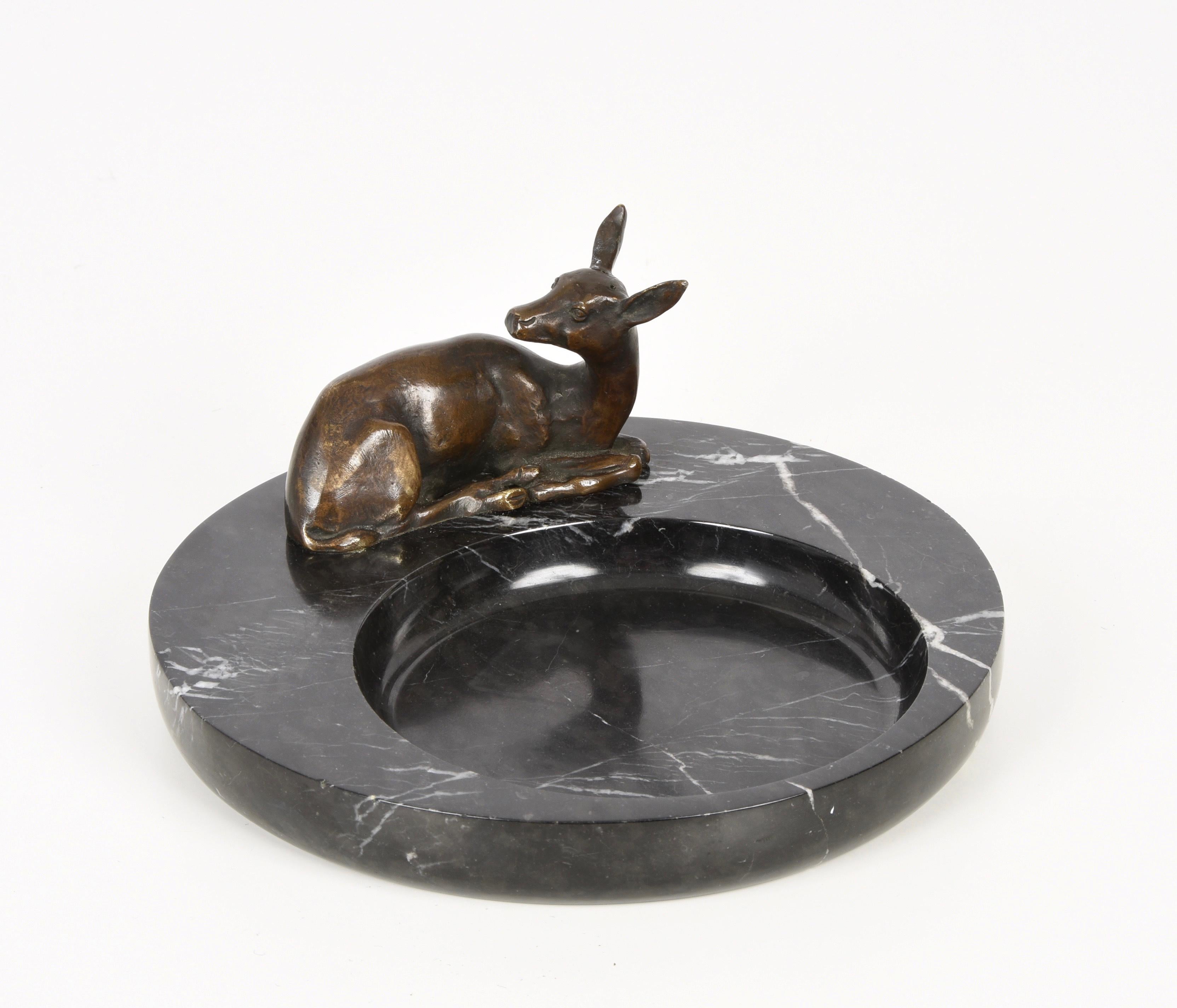 Amazing midcentury ashtray with black marble base with a fantastic bronze deer. This wonderful item was made in Italy during the 1930s.

A relaxed deer figure is laying on a large round black marble base. The whole item conveys tranquillity and