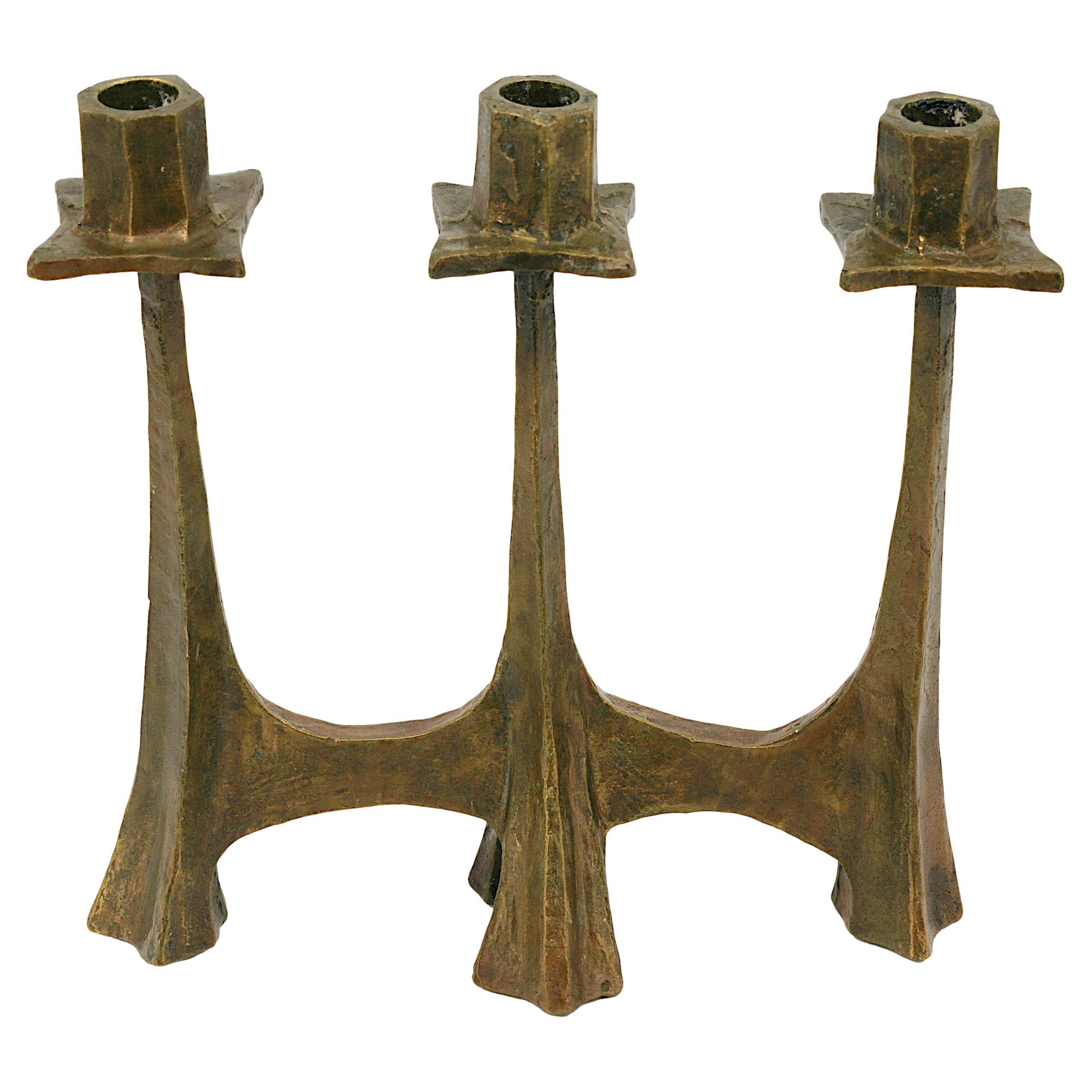 Beautiful French midcentury bronze candelabra, France, circa 1950, crafted in the taste of the Ateliers de Marolles. This liturgical-inspired piece features a raw, rustic, and hand-worked aesthetic characteristic of the Marolles workshop, known for