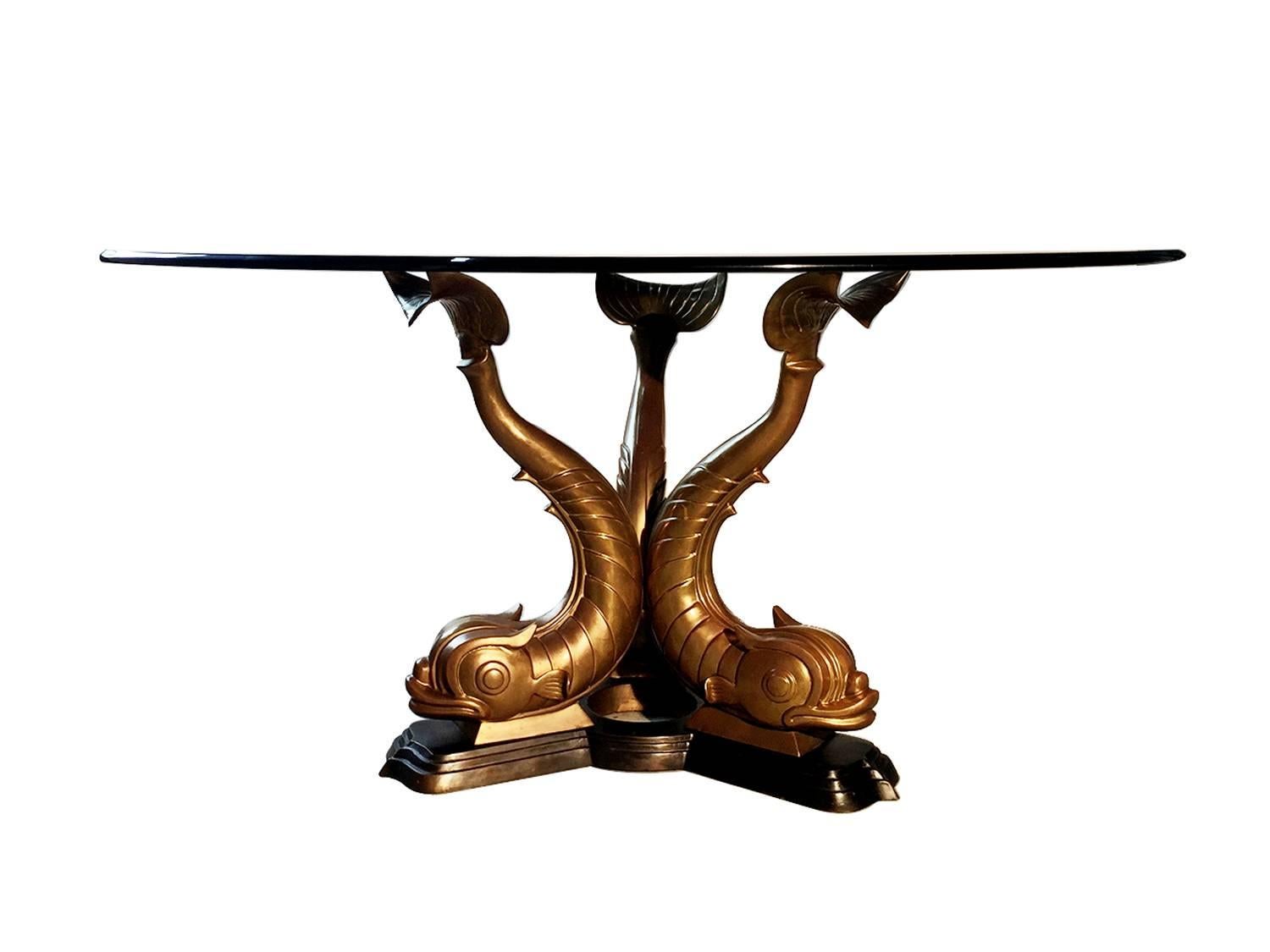 Great midcentury bronze triple dolphin base table,
Has 60” glass top but you can put a smaller or larger glass or marble top if you like.
A heavy bronze nicely cast base.