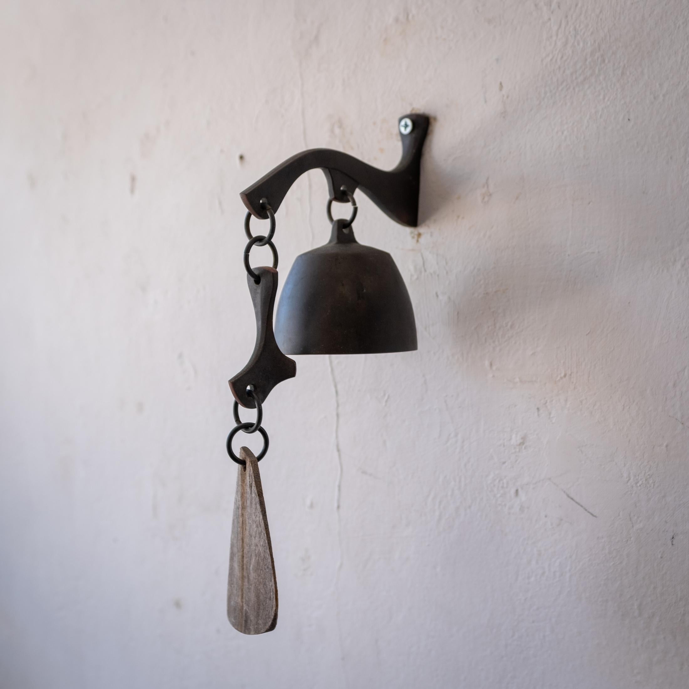 Solid bronze bell with a wood wind catcher. Years of nice patina. Could be used as a doorbell. It has a beautiful pitch.   