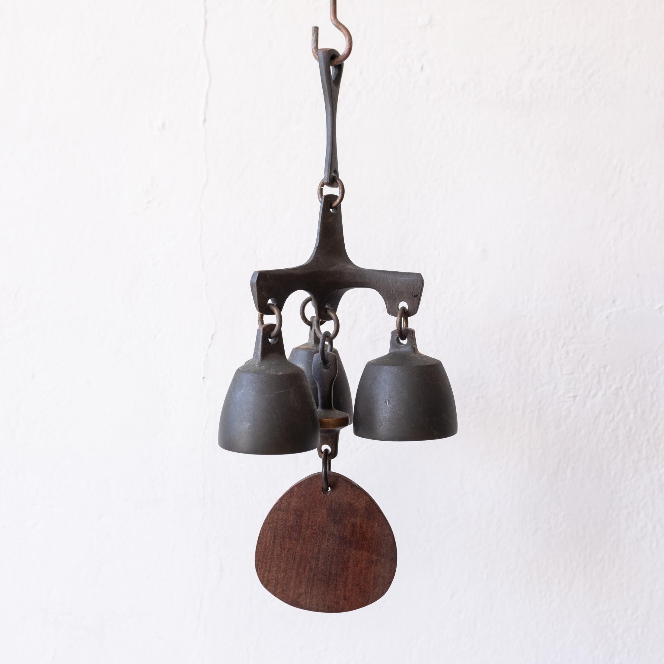 Solid bronze bell with a wood wind catcher. Years of nice patina. Could be used as a doorbell. It has a beautiful pitch.