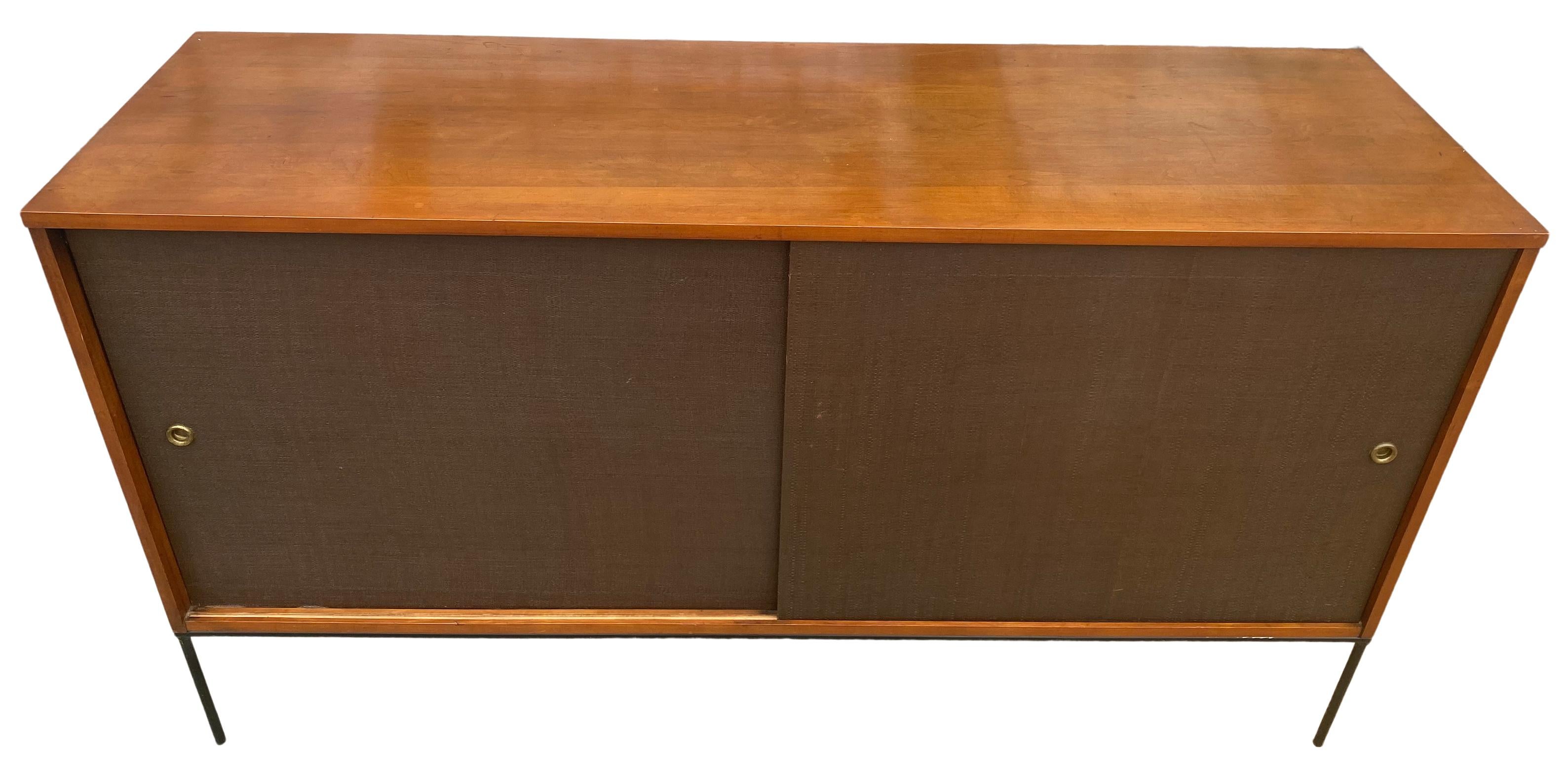 Beautiful midcentury tall credenza by Paul McCobb circa 1950 Planner Group #1514 has 1 adjustable shelves with pins with 1 drawer on the left side and 3 drawers on the right side. Solid maple construction with an original medium Walnut finish. All