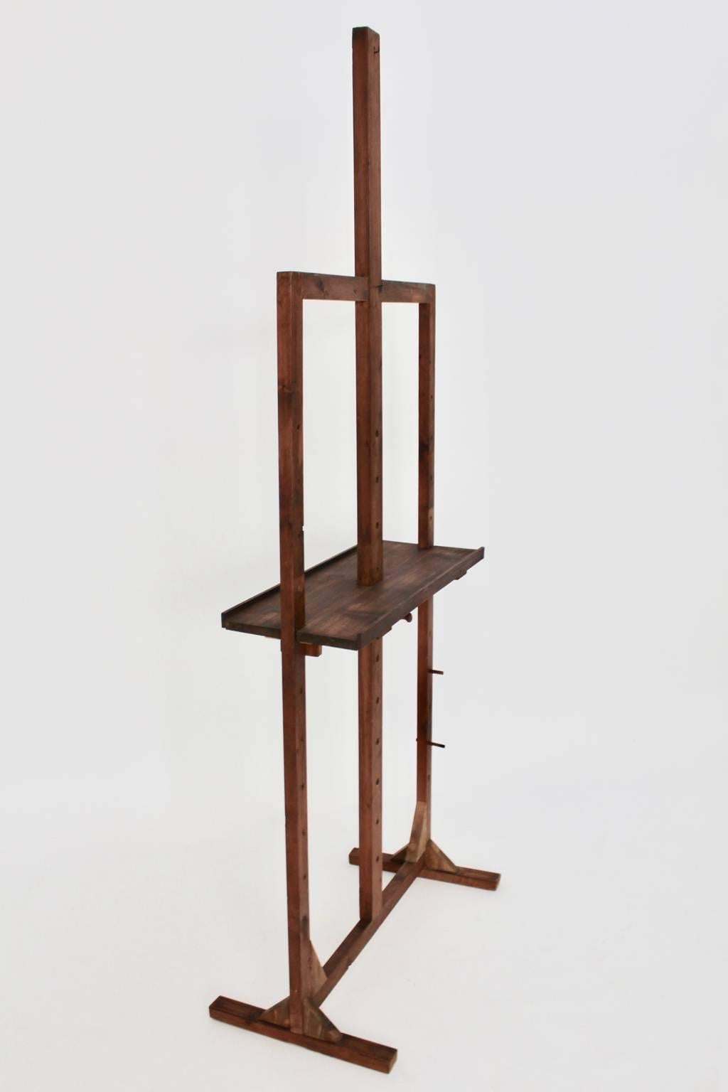 Very decorative brown midcentury easel, Austria, 1950s.

The easel was made of spruce - brown stained. The pad board is adjustable from up to down and for holding a painting with 160 cm height.
Original condition - carefully cleaned 

It is a great