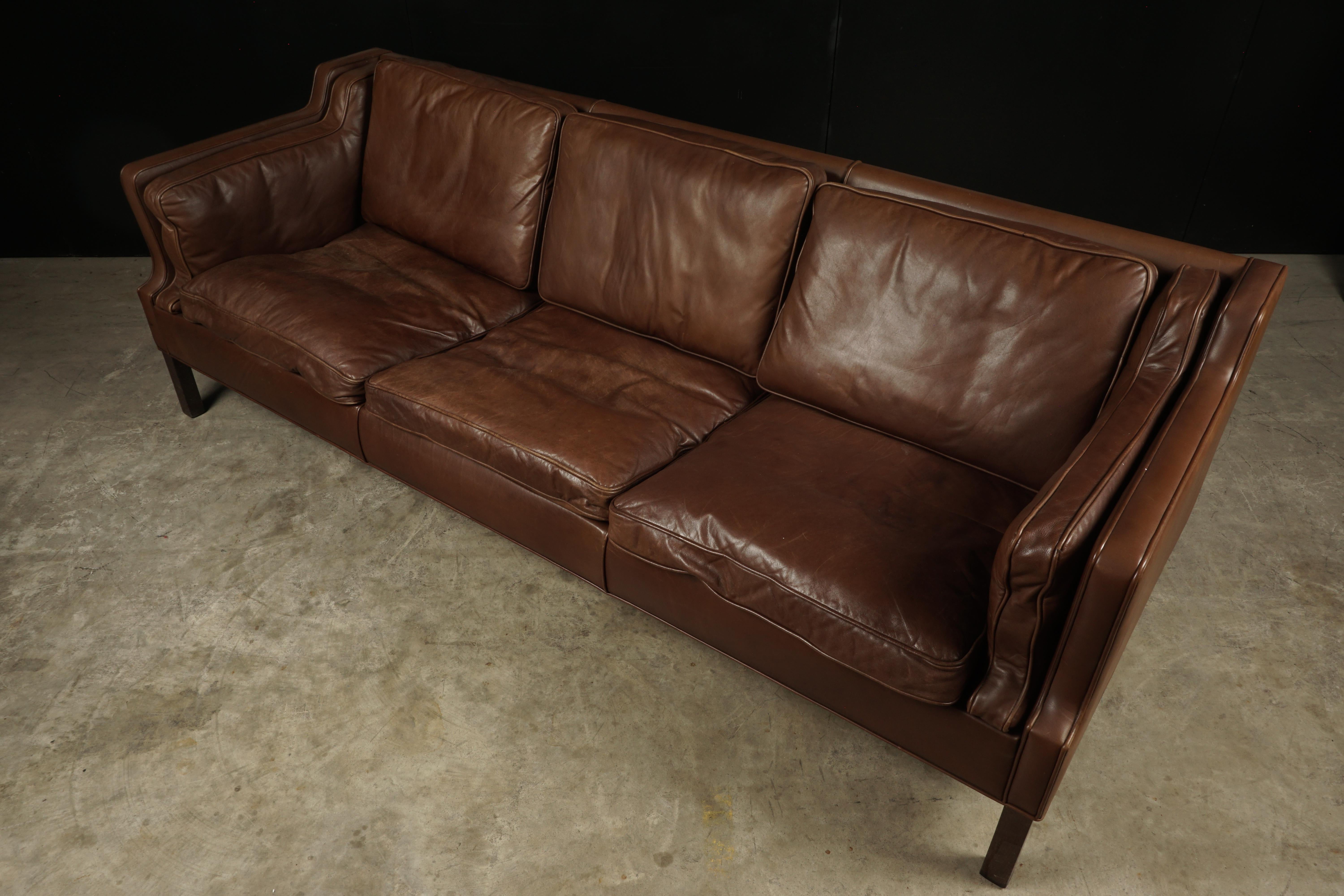 Midcentury brown leather sofa from Denmark, circa 1970. Three-seat sofa with supple brown leather. Light wear and patina.