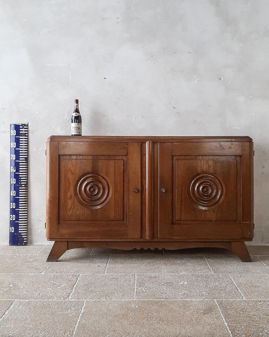 Brown oak sideboard by Charles Dudouyt from the 1940s, with two round panel doors.

Measures: h 91 x w 150 x d 45 cm.