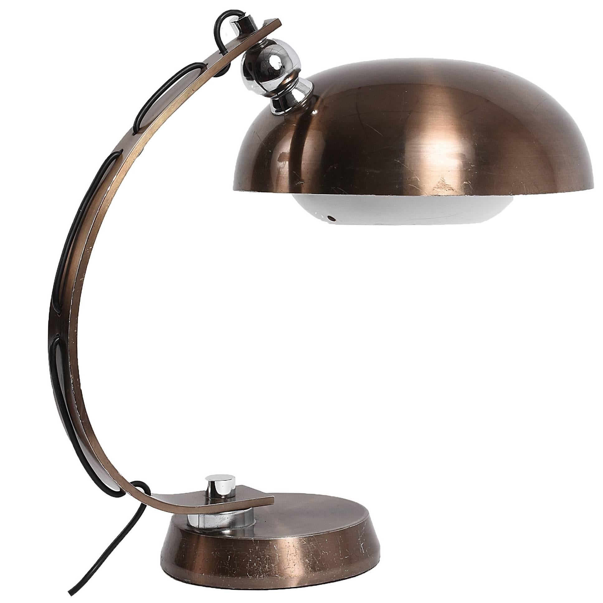 Beautiful midcentury and large brushed bronzed aluminium table lamp, typical of the lighting productions during the 70s. 

The lampshade is adjustable and was produced in Italy during the 1970s probably by Arredoluce

For this incredible item,