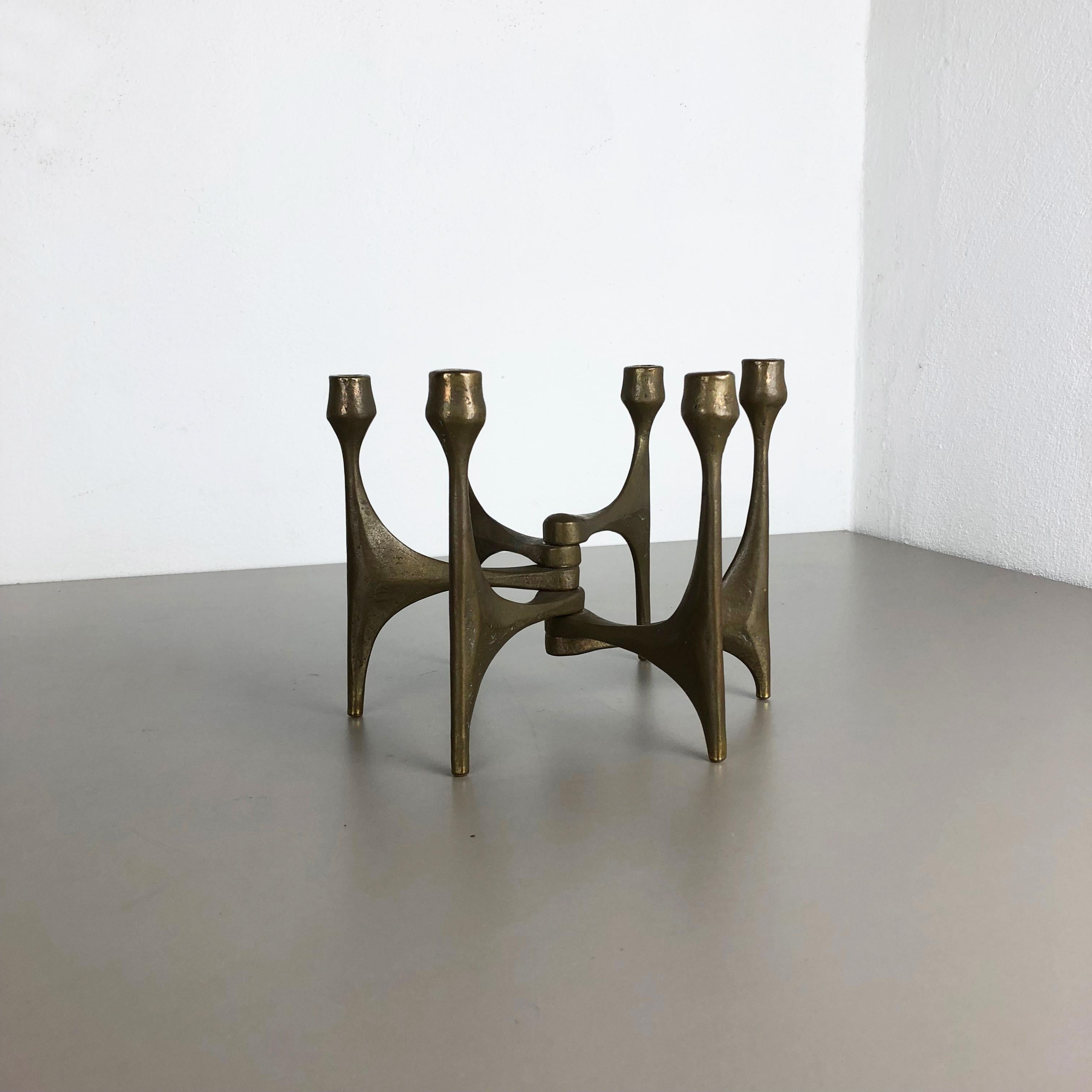 Article: Brutalist candleholder

Origin: Germany

Design producer: Michael Harjes

Material: bronze

Decade: 1960s

Description: This original vintage candleholder, was produced in the 1960s in Germany. Designed and executed by Michael