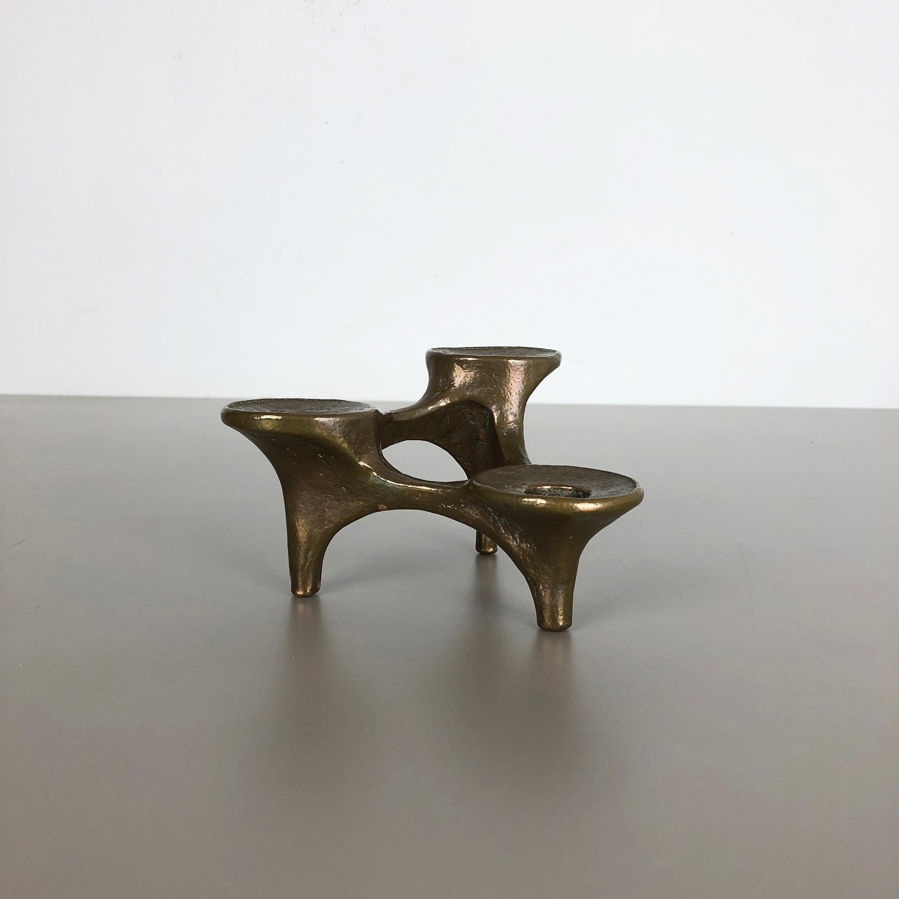 Article: Brutalist candleholder

Origin: Germany

Design producer: Michael Harjes

Material: bronze

Decade: 1960s

Description: This original vintage candleholder, was produced in the 1960s in Germany. Designed and executed by Michael