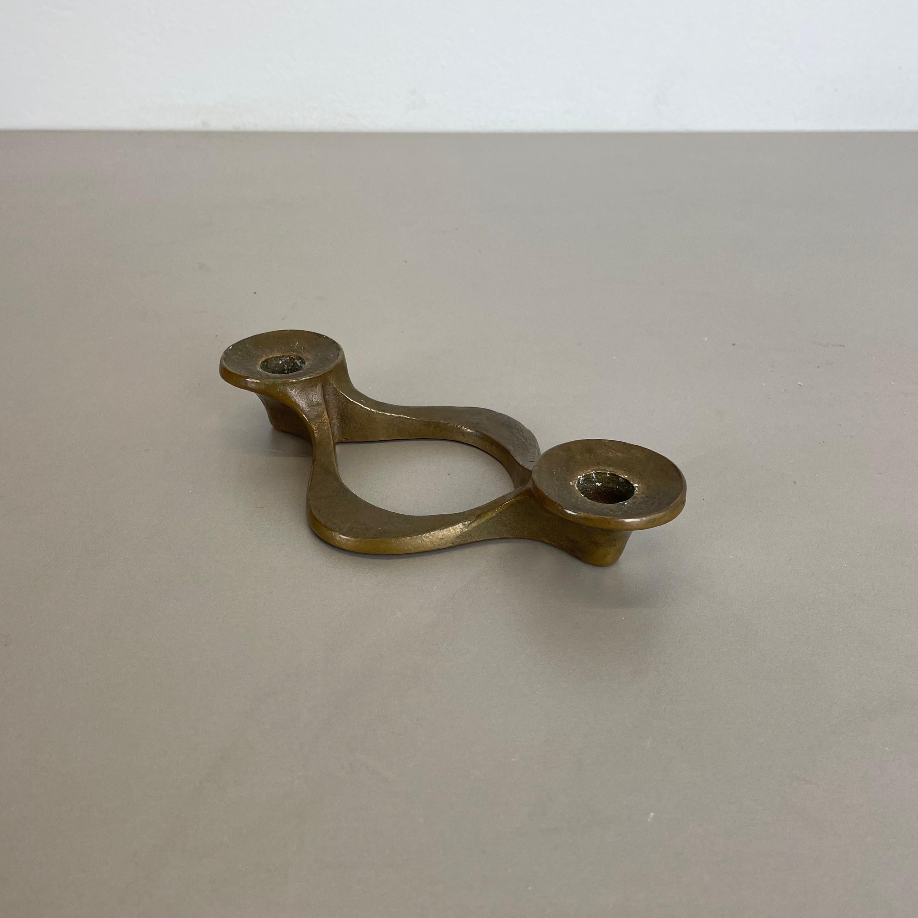 Article: Brutalist candleholder

Origin: Germany

Design producer: Michael Harjes

Material: bronze

Decade: 1960s

Description: This original vintage candleholder was produced in the 1960s in Germany. Designed and executed by Michael