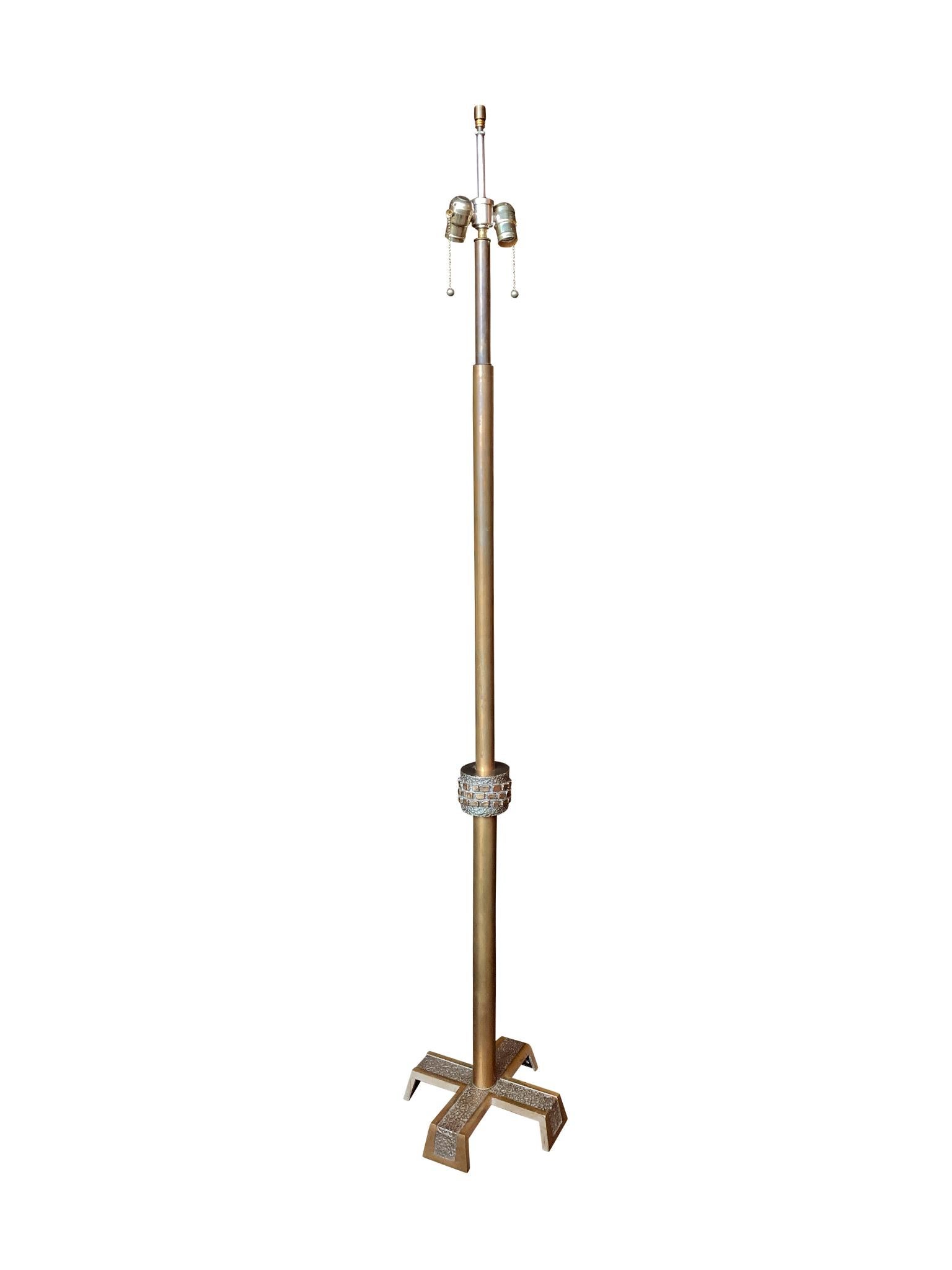 This tall Mid-20th Century Brutalist floor lamp is comprised of a mixed-metal body and custom-fitted with a new line shade. Characteristic of the Brutalist style, the design is minimalist with sparse but striking adornment that evoke rough,