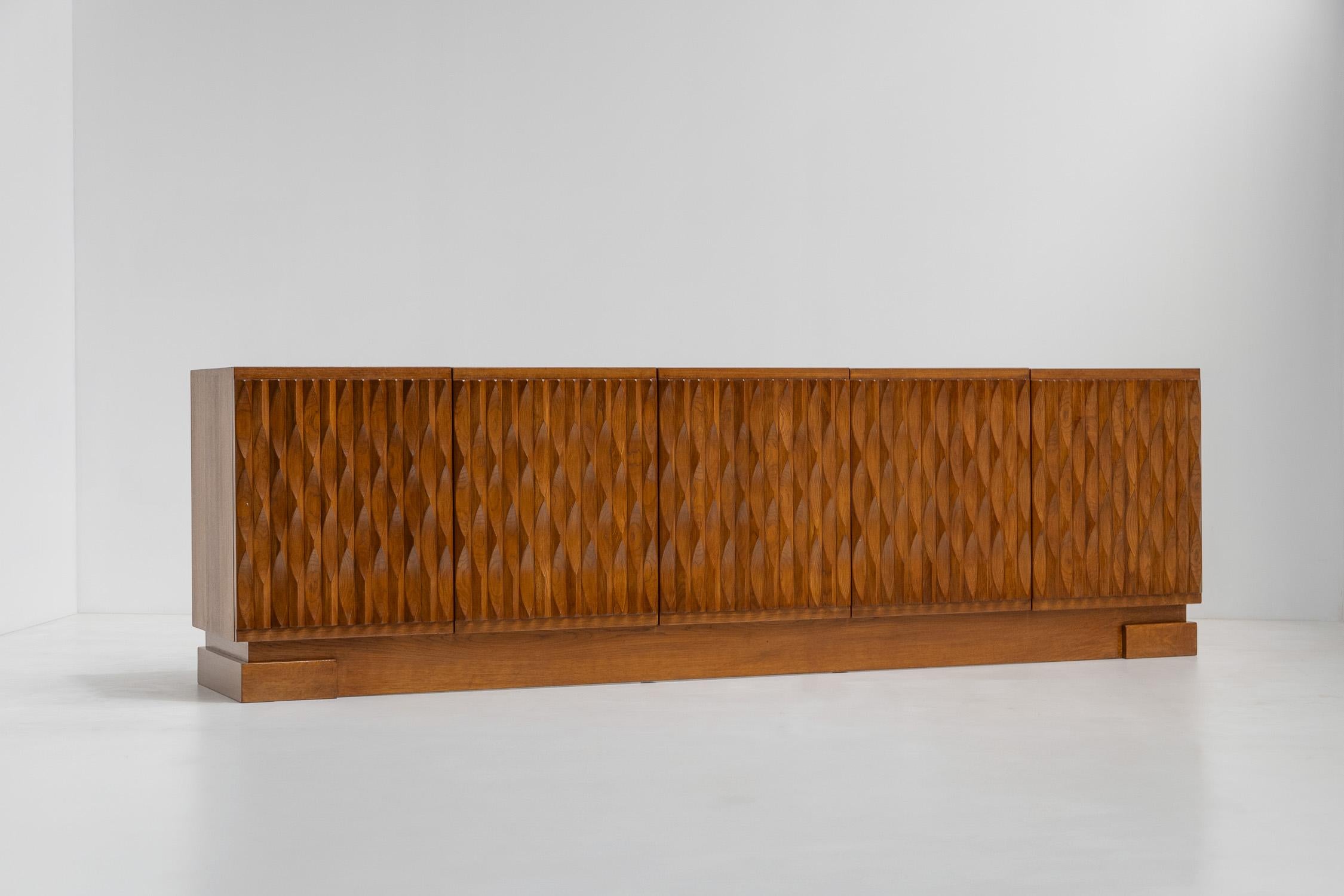 Impressive graphic, brutalist-style design credenza, Belgium

Because of its dimensions and the beautiful sculptured doors, it beats all the other sideboards out there. The woodwork is out of this world, and the blonde oak gives a delightful warmth