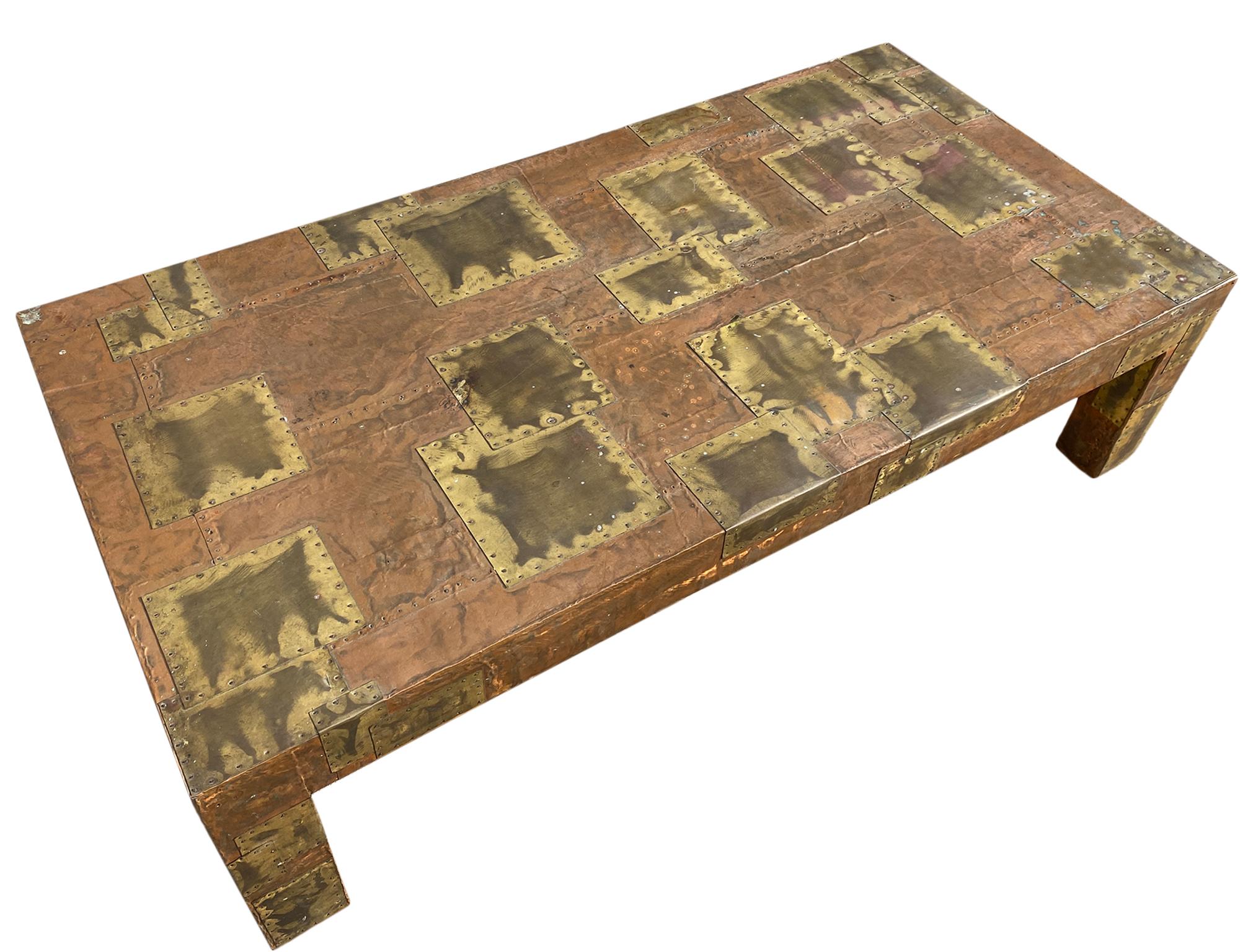 Midcentury Brutalist patchwork coffee table style of Paul Evans. Wood structure with brass and copper sheets nailed down. Lots of patina and oxidation. Aged beautifully. No Label no Tag. very heavy and sturdy. Legs are 4