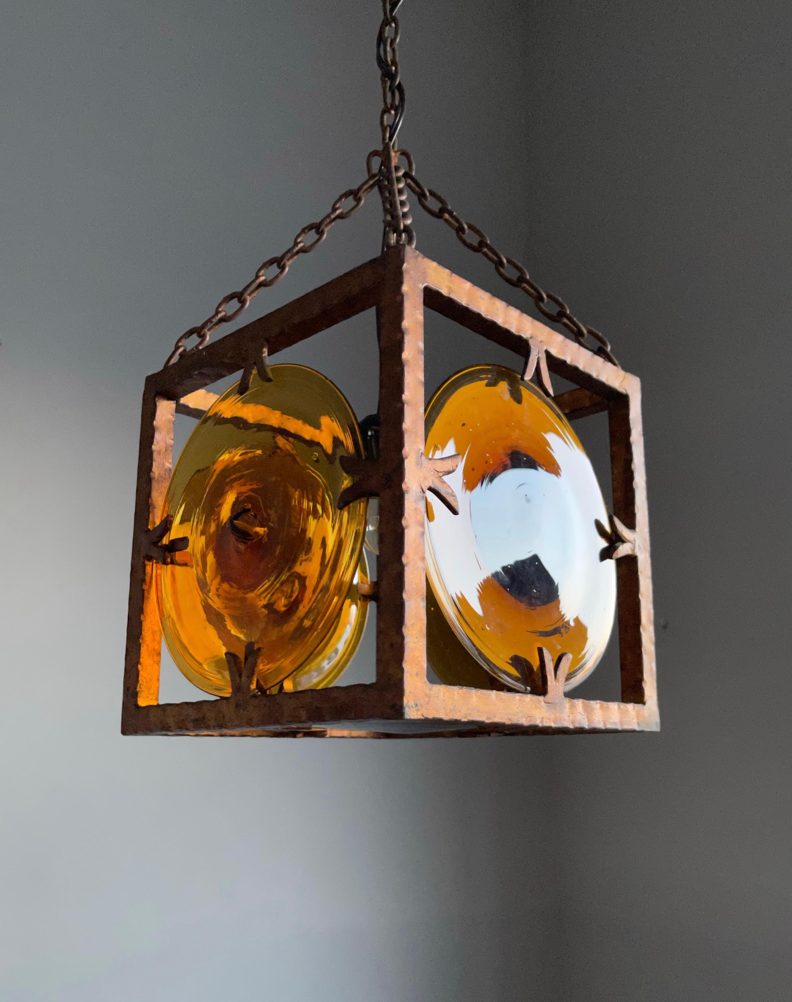 Rare design pendant with large, mouth blown art glass discs in gilt wrought iron frame.

If you are looking for a striking and extraordinary light fixture to grace your midcentury living or work space then this, Italian work of lighting art could be