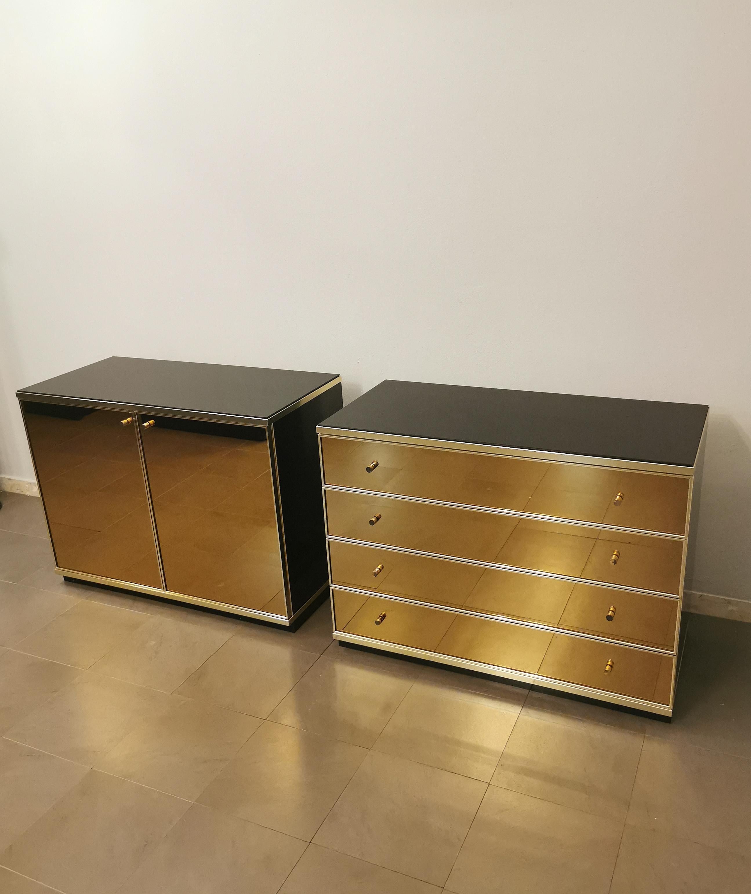 A buffet and a chest of drawers designed by the Italian designer Renato Zevi in the 70s. This elegant set has a black lacquered wood structure, dark glass top and doors and drawers in bronzed mirrored glass with sand-colored suede inside. Finishes