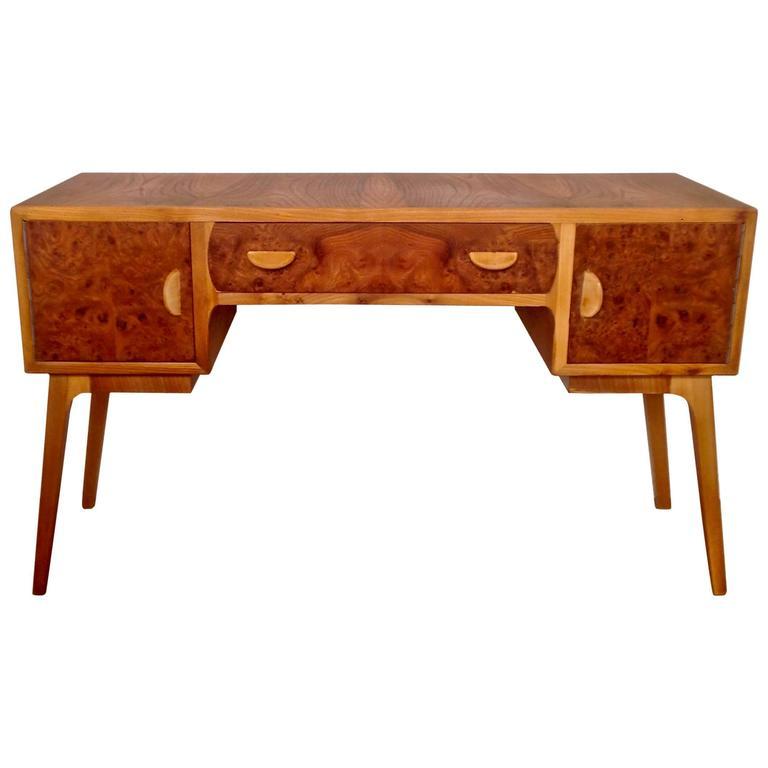 Marvellous small Midcentury sideboard or dressing table. Made of walnut or teak and burl wood, with one drawer and two small cabinets.