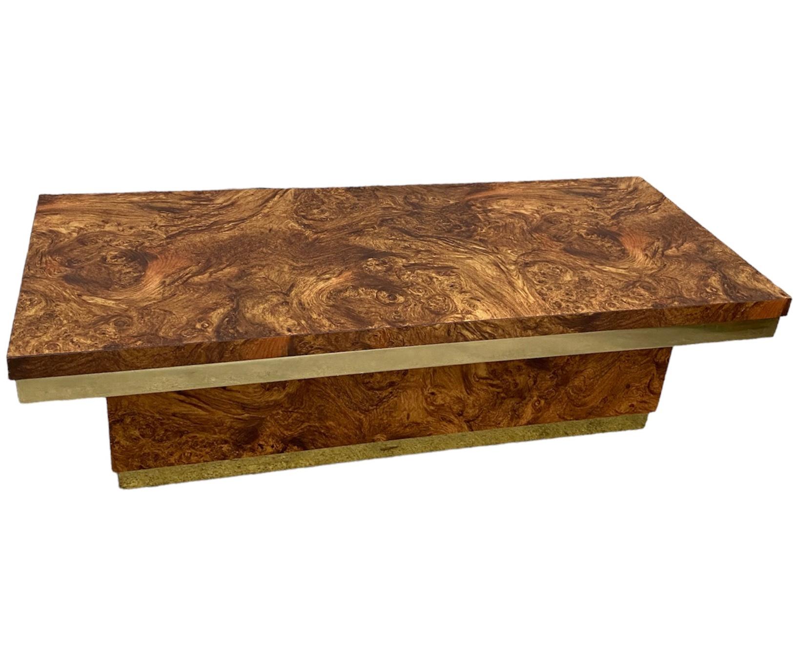 This beautiful midcentury coffee table features stunning burl wood panels and brass accents. This piece will fit perfectly in any contemporary or midcentury style space. Laminate is very durable and perfect for those who entertain often! 