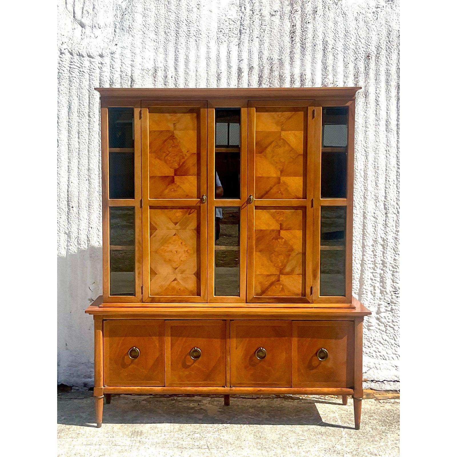 Fantastic vintage Midcentury Breakfront. Done in the manner of American of Martinsville. I’m pretty sure it is, it has all the same inspector markings, but they did not always stamp the breakfronts. Anyway. It’s a real beauty. Parquet Burl Wood