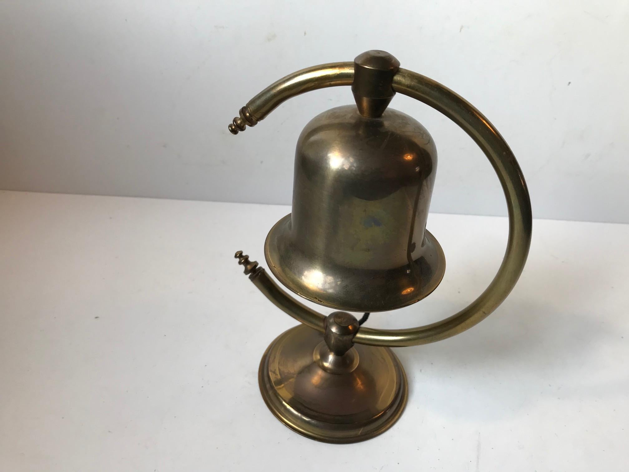 Unusual arched table or desk bell in brass. Designed and manufactured by Cawa in Denmark during the 1960s. Makers mark beneath its base.