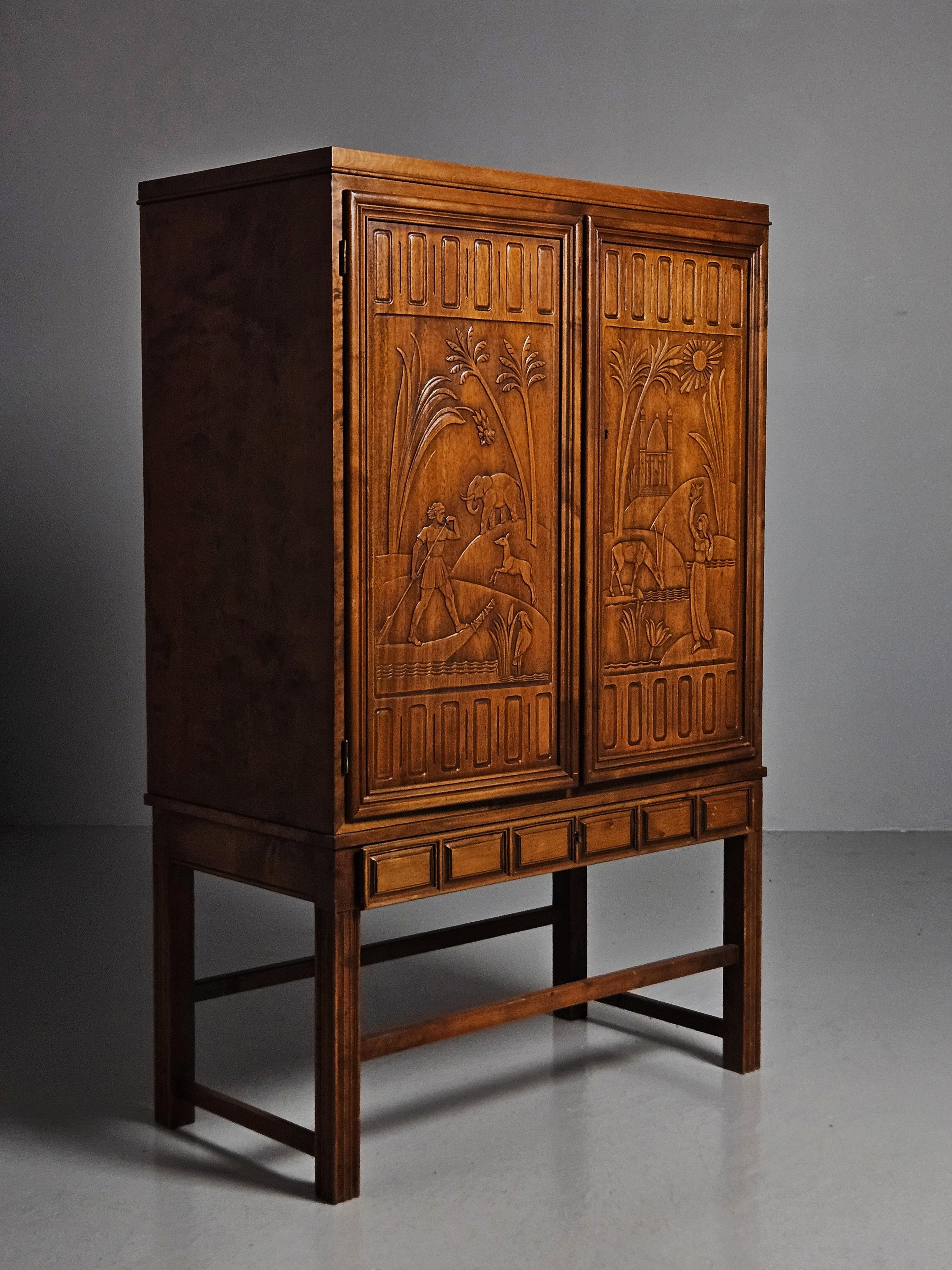 Cabinet made by Eugen Höglund and made in Sweden during the 1950s. 

Produced in stained beech with a beautiful carved relief. 
