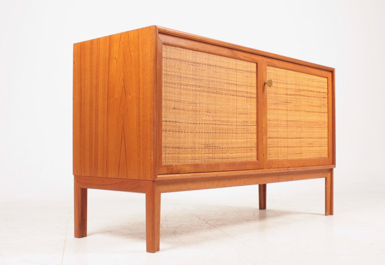 Cabinet with cane door in teak. Designed by MAA. Alf Svensson and made by Bjästa cabinetmakers Sweden. Great original condition.
   