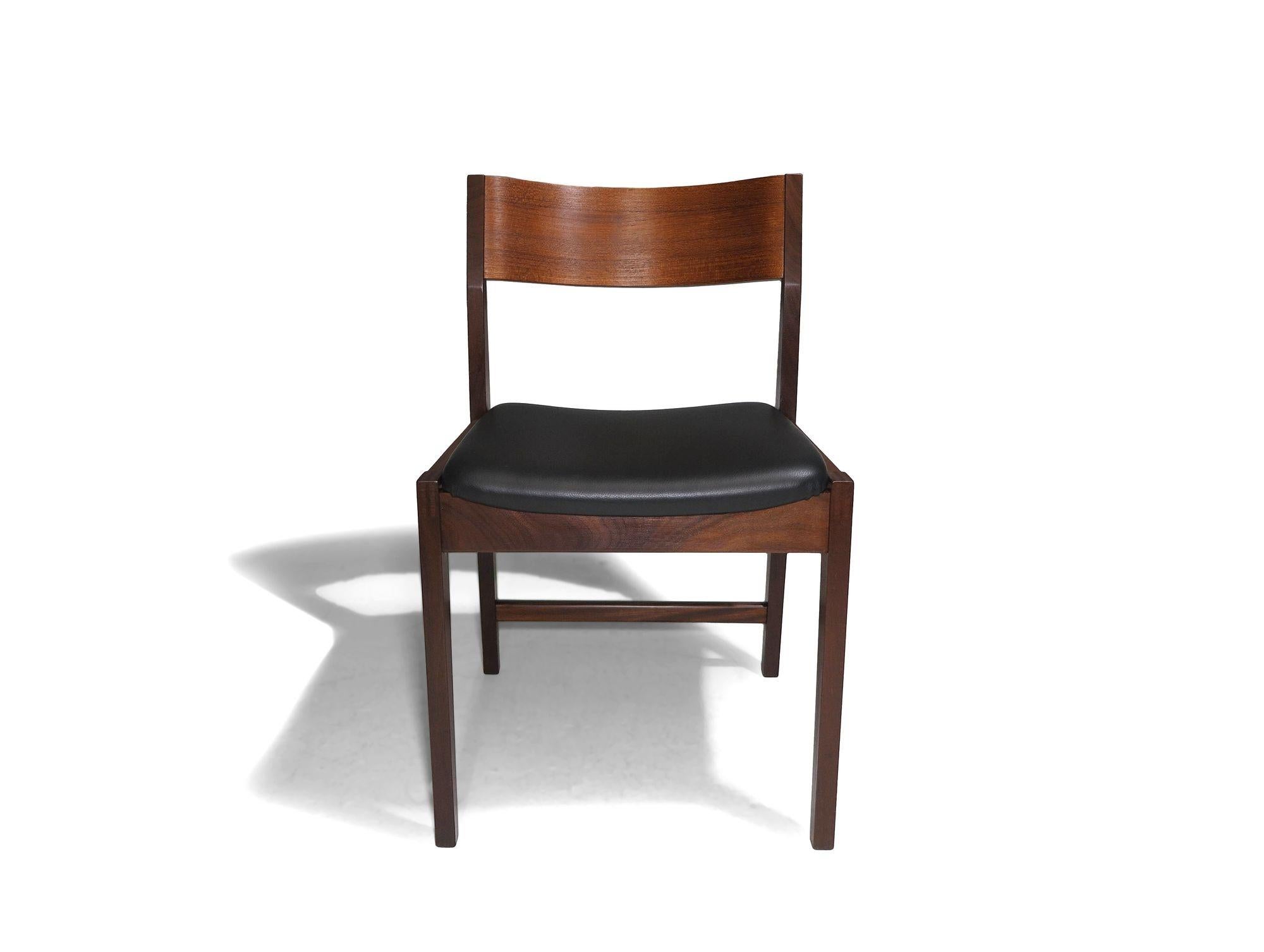 Mid-Century Danish dining chairs designed by Paul Cadovius for Cado. Crafted with a solid teak frame featuring sturdy exposed joinery and a molded curved backrest. The chairs are robust and suitable for commercial environments. Upholstered in new