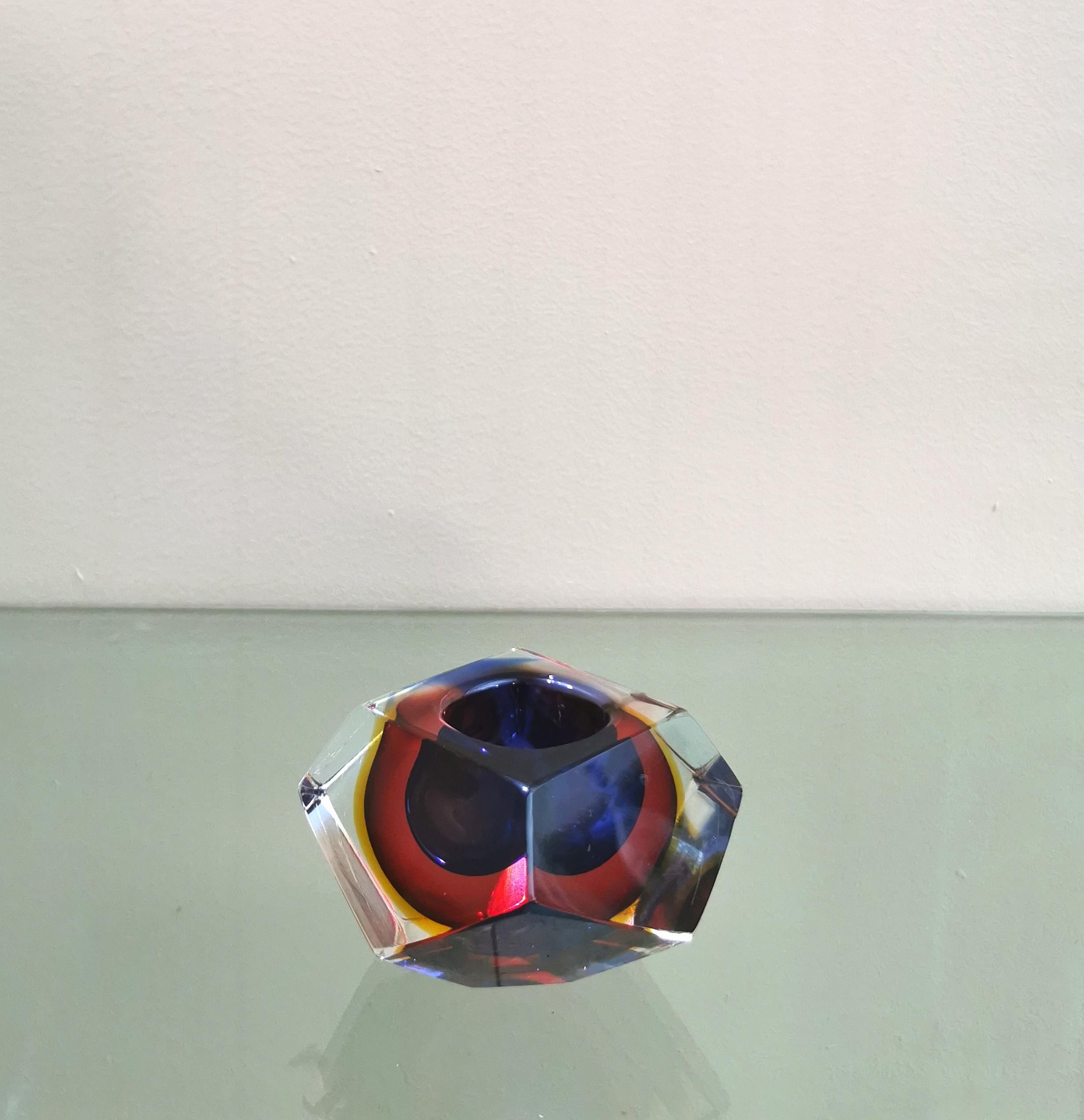 Candle holder / ashtray designed by the Italian designer Flavio Poli, produced in the 70s. The candle holder was made of Murano glass with the particular sommerso technique, it has a particular shape of a diamond, with bright colors, such as