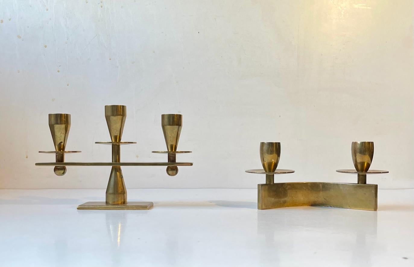 Two slightly different candleholders fashioned from solid bronze (heavy stock). One for two candles and one for 3. Both uses regular sized candles. Designed and made by Kara in Copenhagen Denmark during the early 1960s. Reminiscent in style to