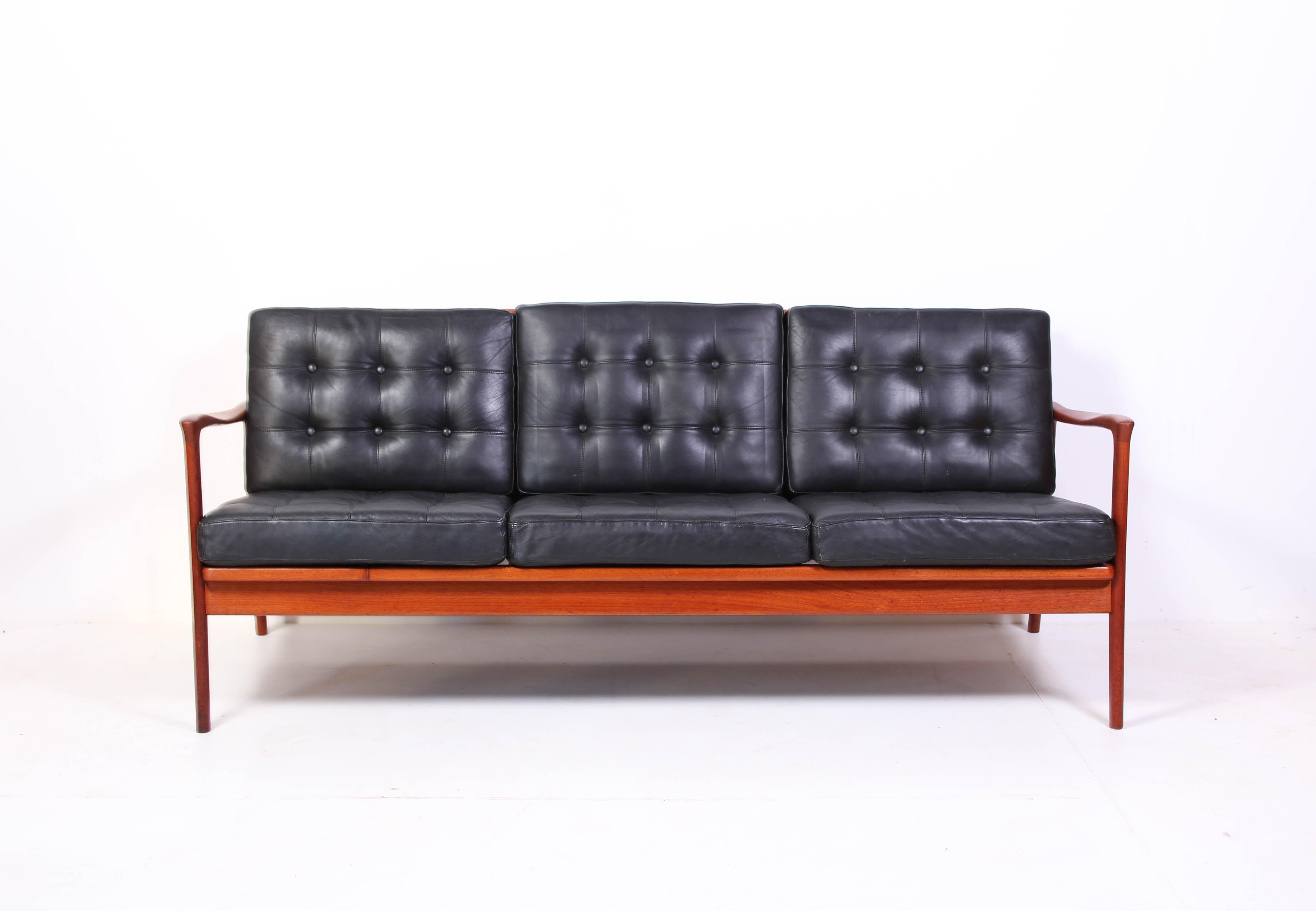 Midcentury teak and black leather sofa by Swedish designer Carl-Erik Johansson. The model is called 