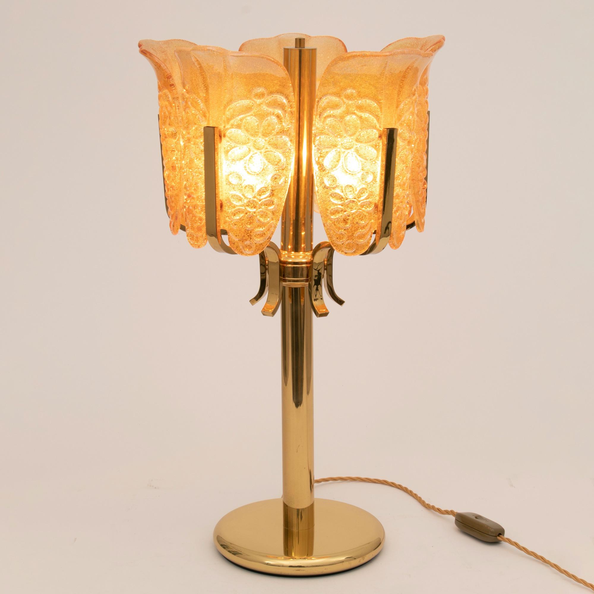 A midcentury Carl Fagerlund five branch brass and orrefors glass table lamp
with unusual floral embossed amber glass shades
Italy, circa 1960
Measures: H 63cm, W 36cm, D 36cm.