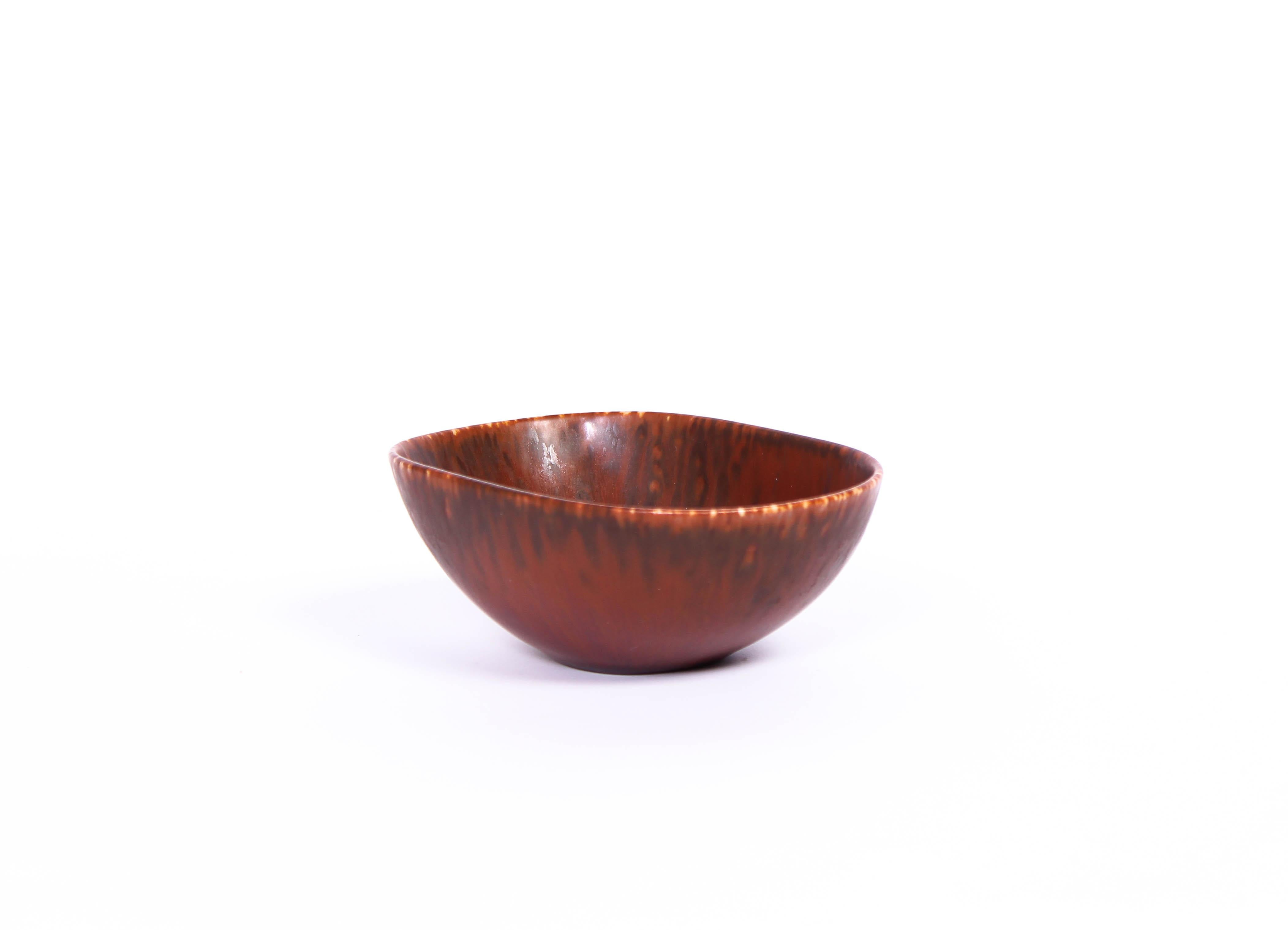 A brown ceramic bowl designed by Carl-Harry Stålhane and produced by Rörstrand. The bowl is in good condition and very decorative.