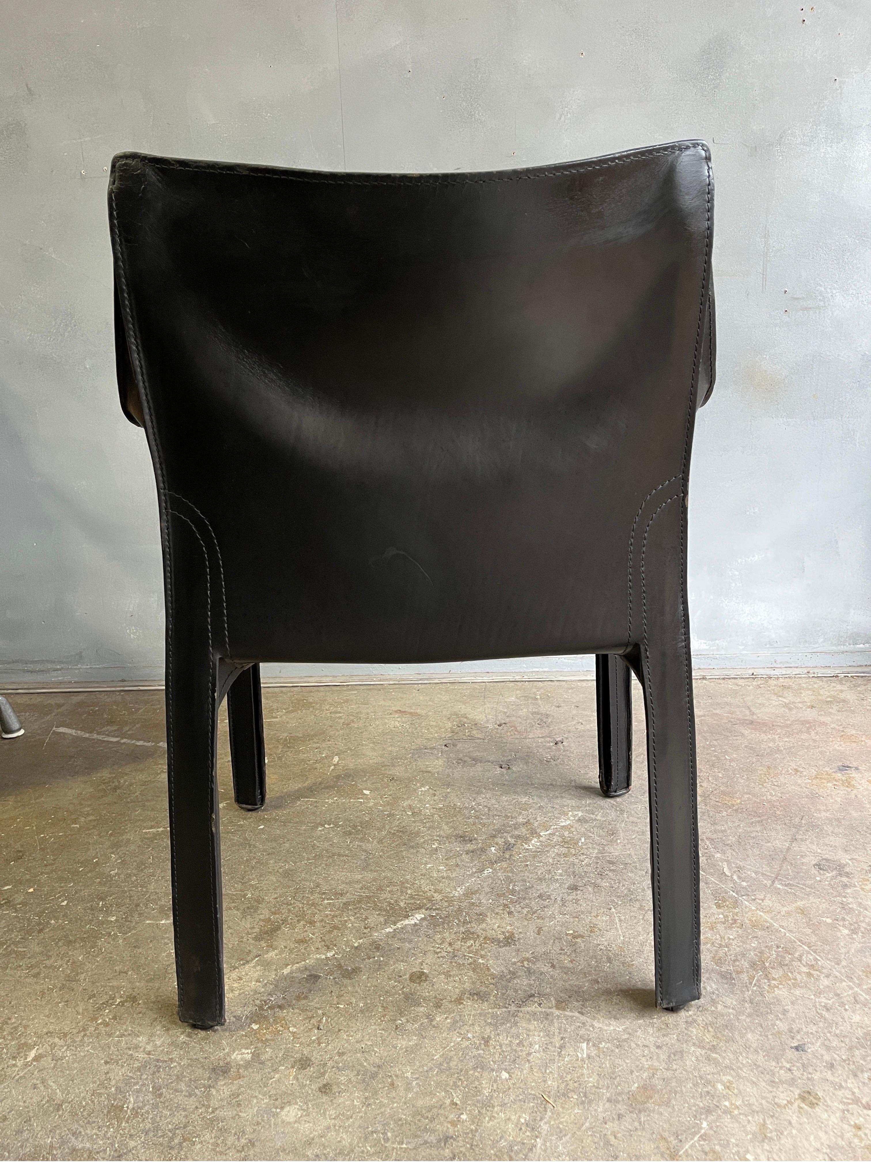 Mario Bellini Cab arm in black saddle leather wrapped around a steel frame. Displaying age appropriate wear and patina with minor scuffs to seat as expected. This design is part of the permanent collection at the MoMA.

Model 413.