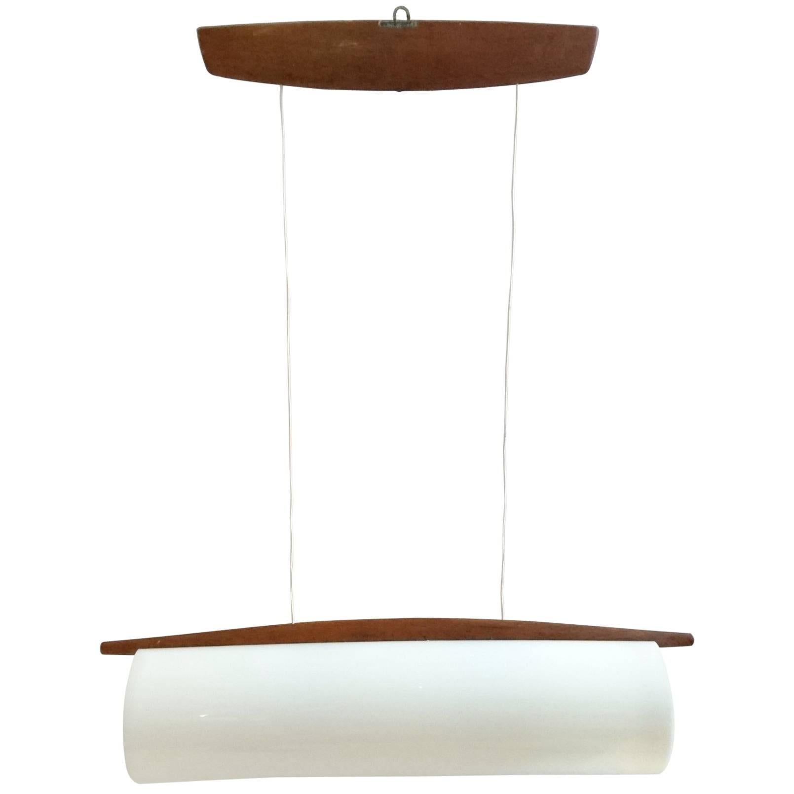 Cylindrical ceiling lamp adjustable in height and made from white plexiglass and oak. This lamp has model number 554, which is rare and was designed by Uno and Osten Kristiansson. Produced by Luxus in Vittsjö, Sweden. The original sticker from the