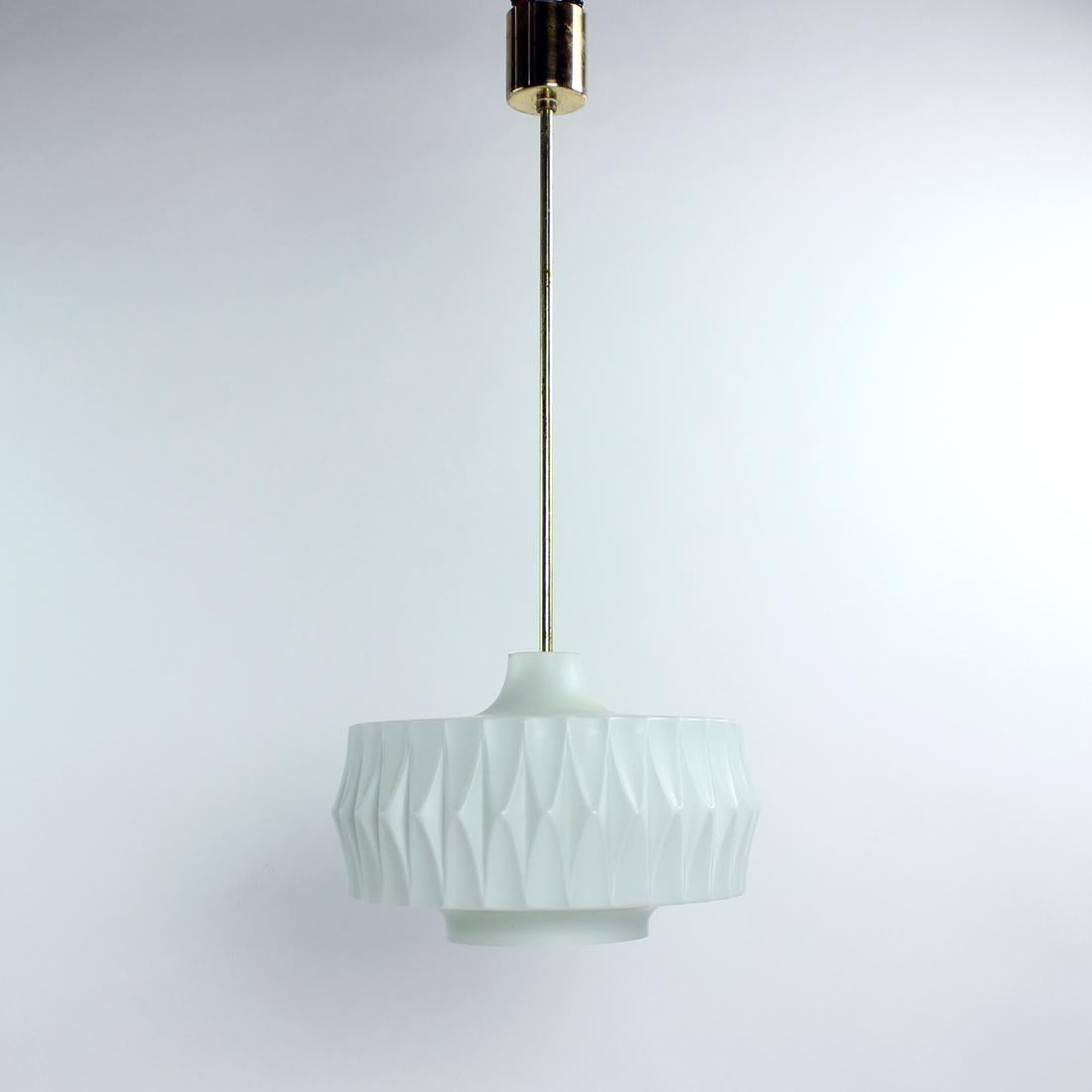 Beautiful midcentury design ceiling light in a striking combination. The pendant was produced in Czechoslovakia in 1960s and was used until recently in a big auditorium. The elegant design shiel is made of white opaline glass in matt finish with