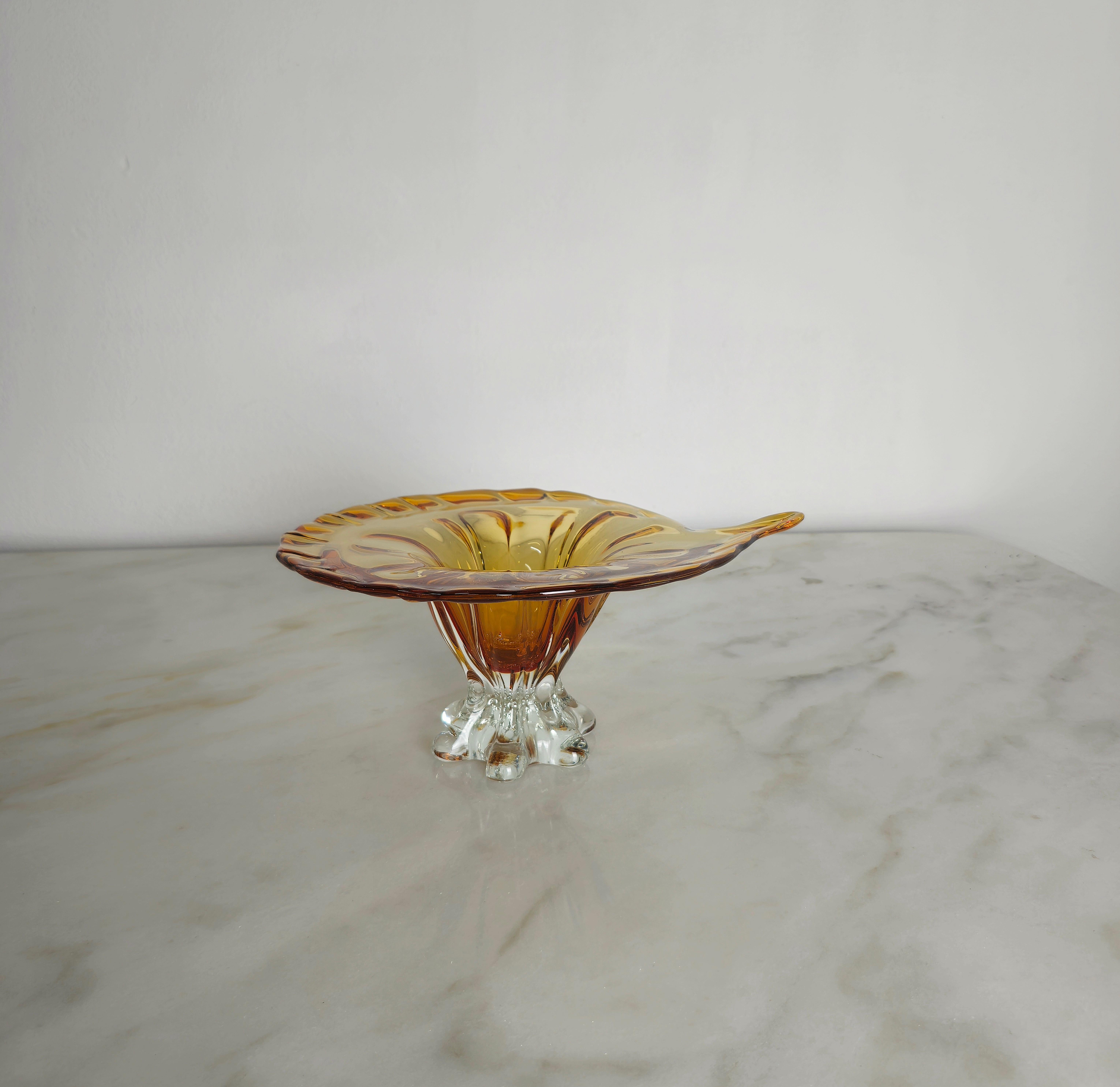 Support/centre de table de forme particulière en verre de Murano dans la teinte du caramel avec base transparente. Fabriqué en Italie dans les années 70.



Note : Nous essayons d'offrir à nos clients un excellent service, même pour les envois dans
