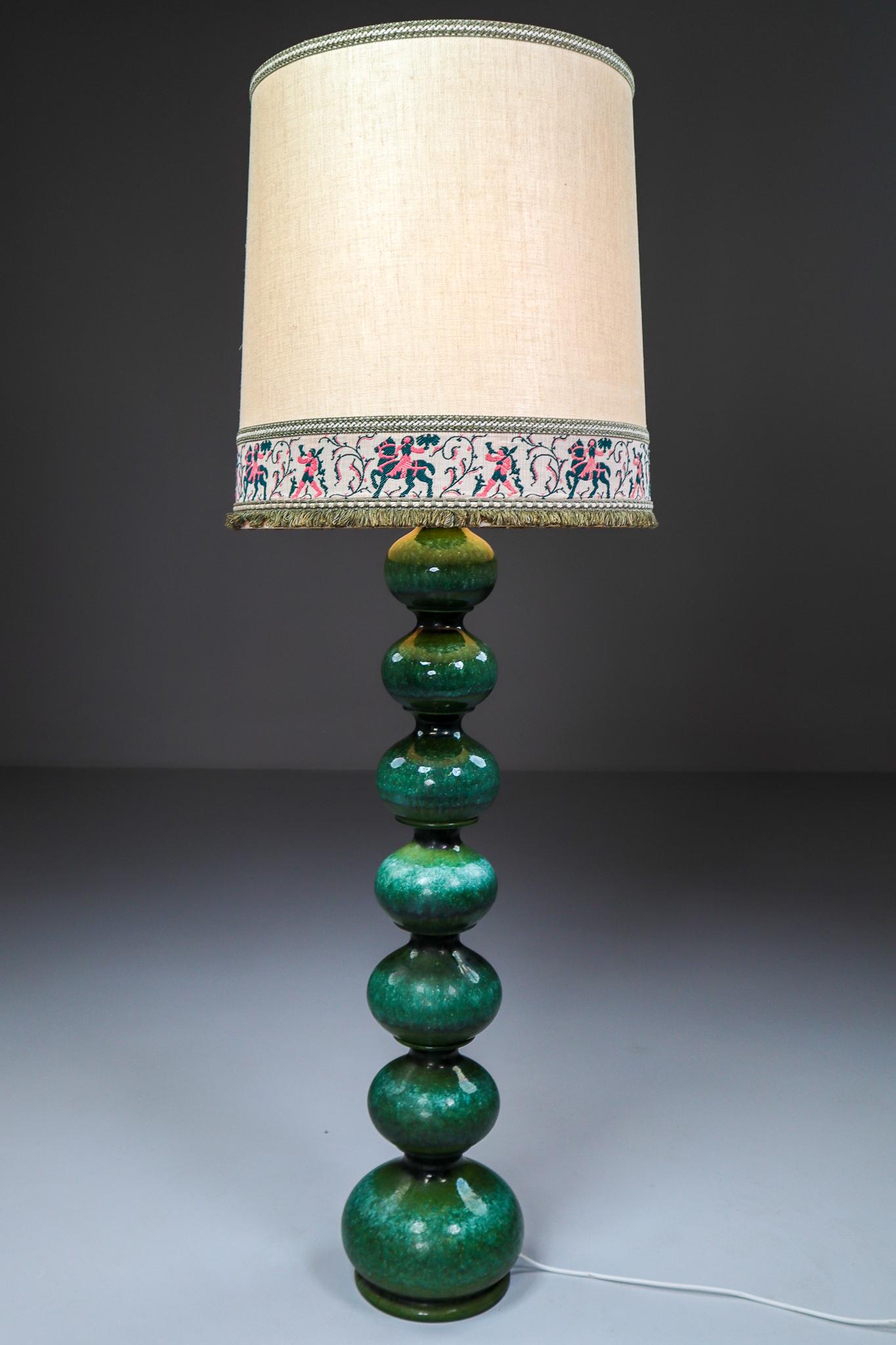 Exceptional ceramic bubble floor lamp made in Germany by Kaiser Leuchten, 1960s. Beautiful sculptural piece made of handmade ceramic in rich glazed green tones. Original lampshade with embroidered design. The light is compatible with the US/UK/
