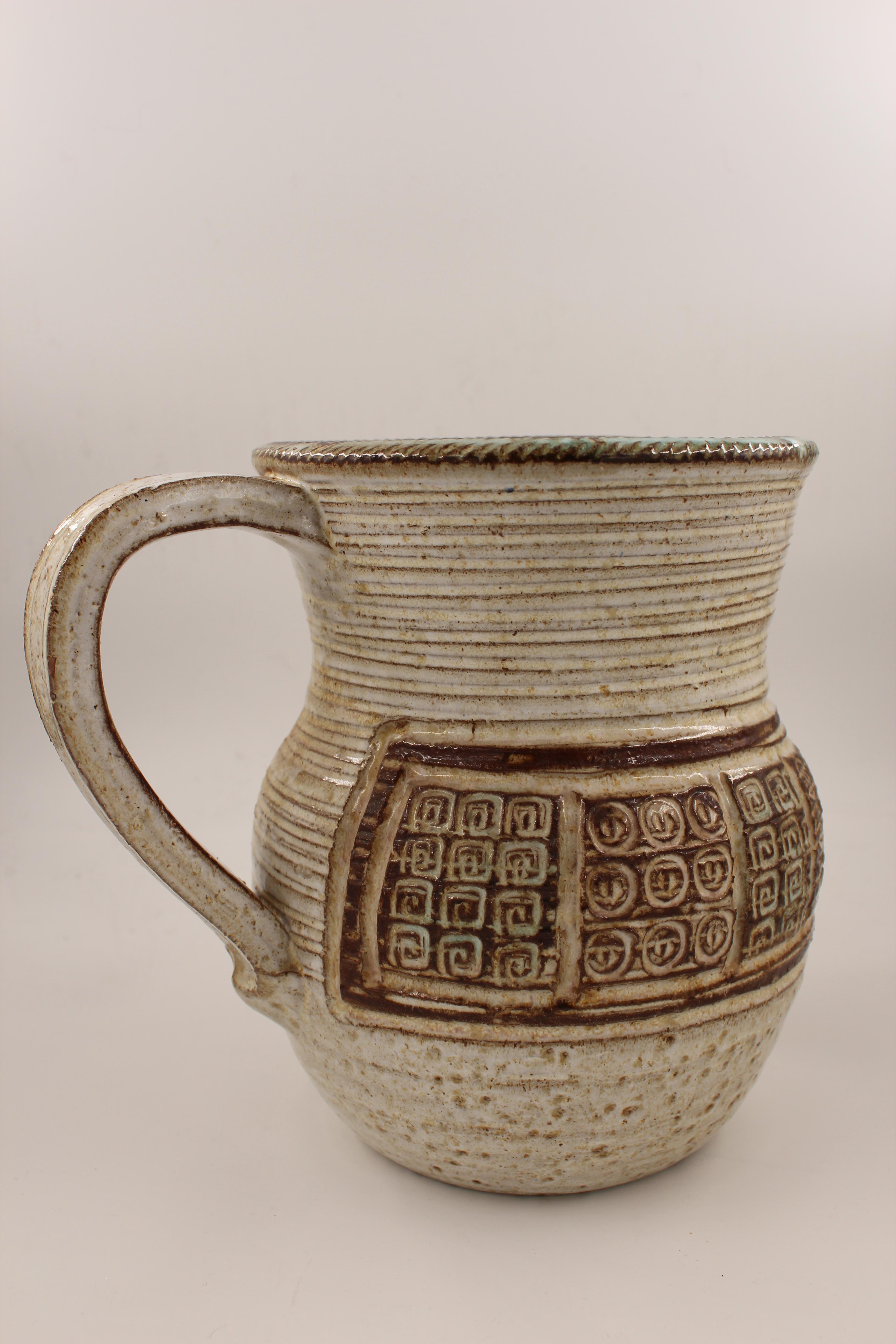 Midcentury ceramic glazed pitcher 1960s by Marcel Giraud, Vallauris, France.
Marcel Giraud (born 1937), from Vallauris, France. He became an apprentice potter at the Rubino workshop. He opened his own studio in 1960 creating mostly utilitarian ware.