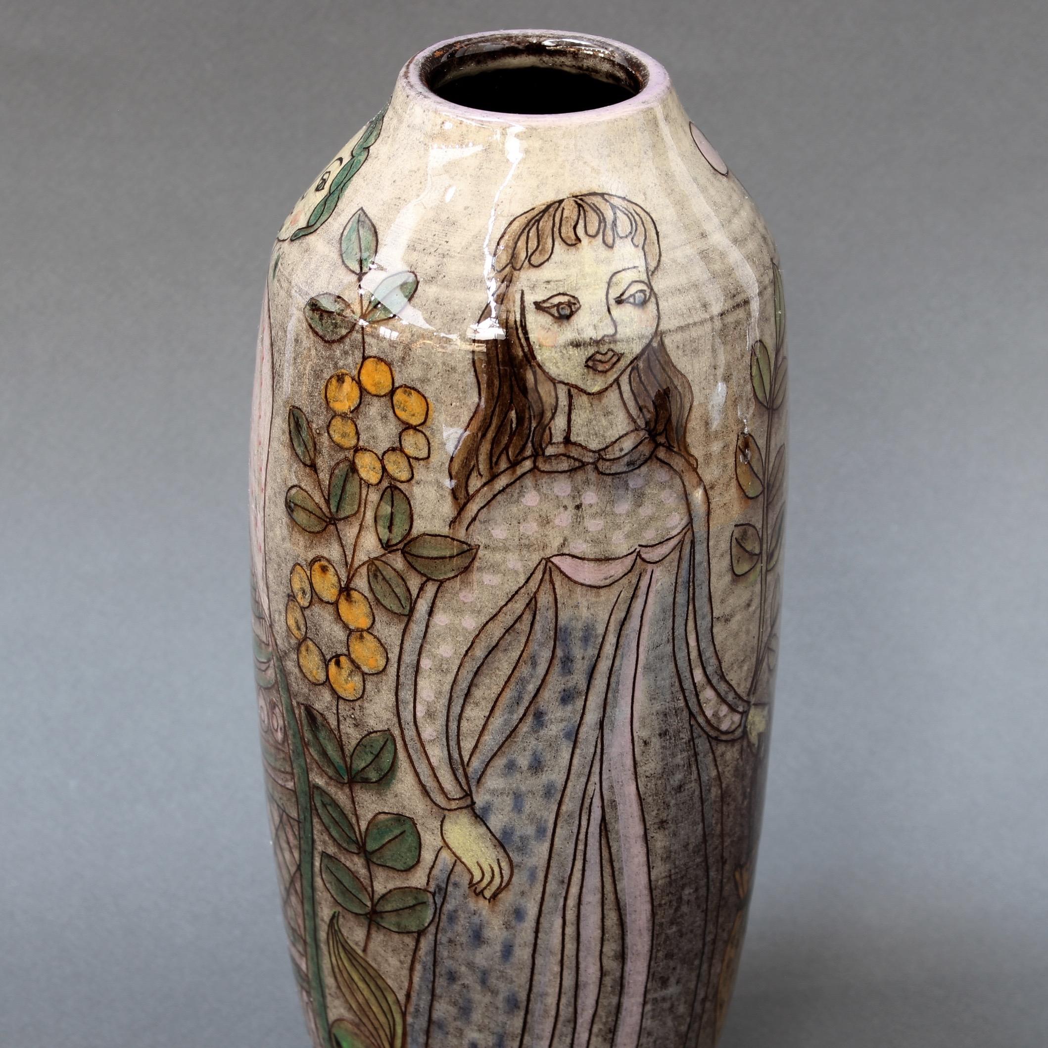 Midcentury ceramic glazed vase, circa 1960s. Acquired in France, this stunning vase has an elegant sheen with painted decoration of three women with flowers and plants. Classically shaped with head-turning style and grace, it would surely be a