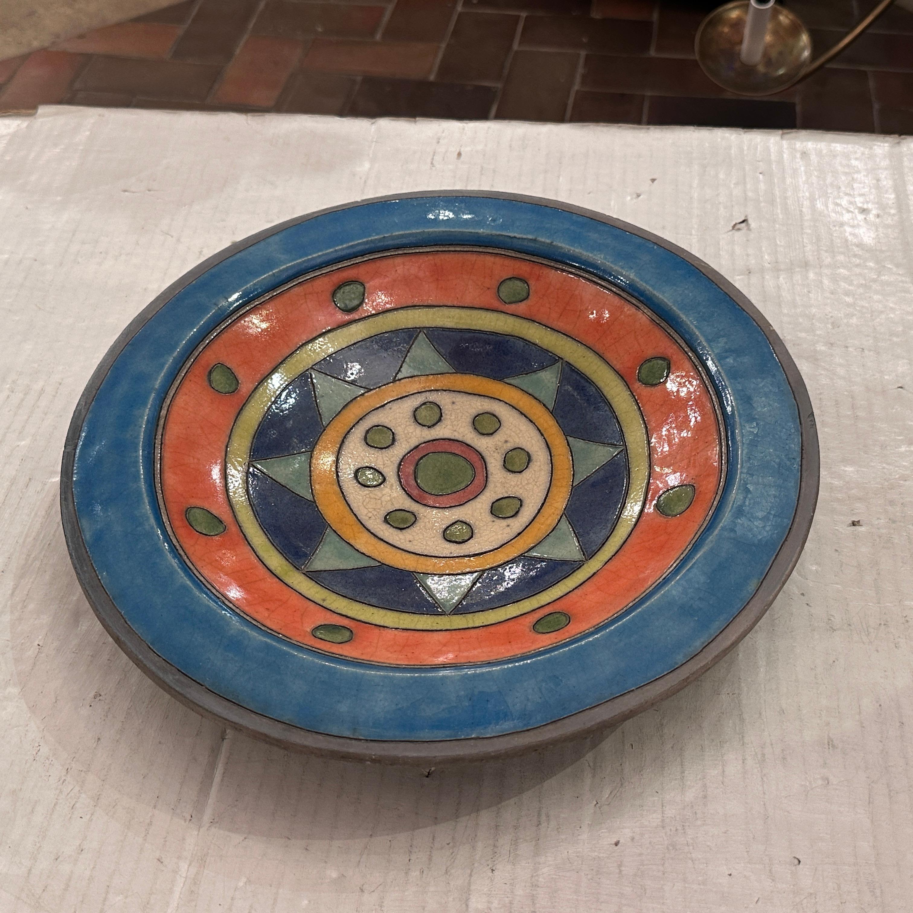 A circa 1970's Italian col0r-glazed plate.

Measurements:
Diameter: 13