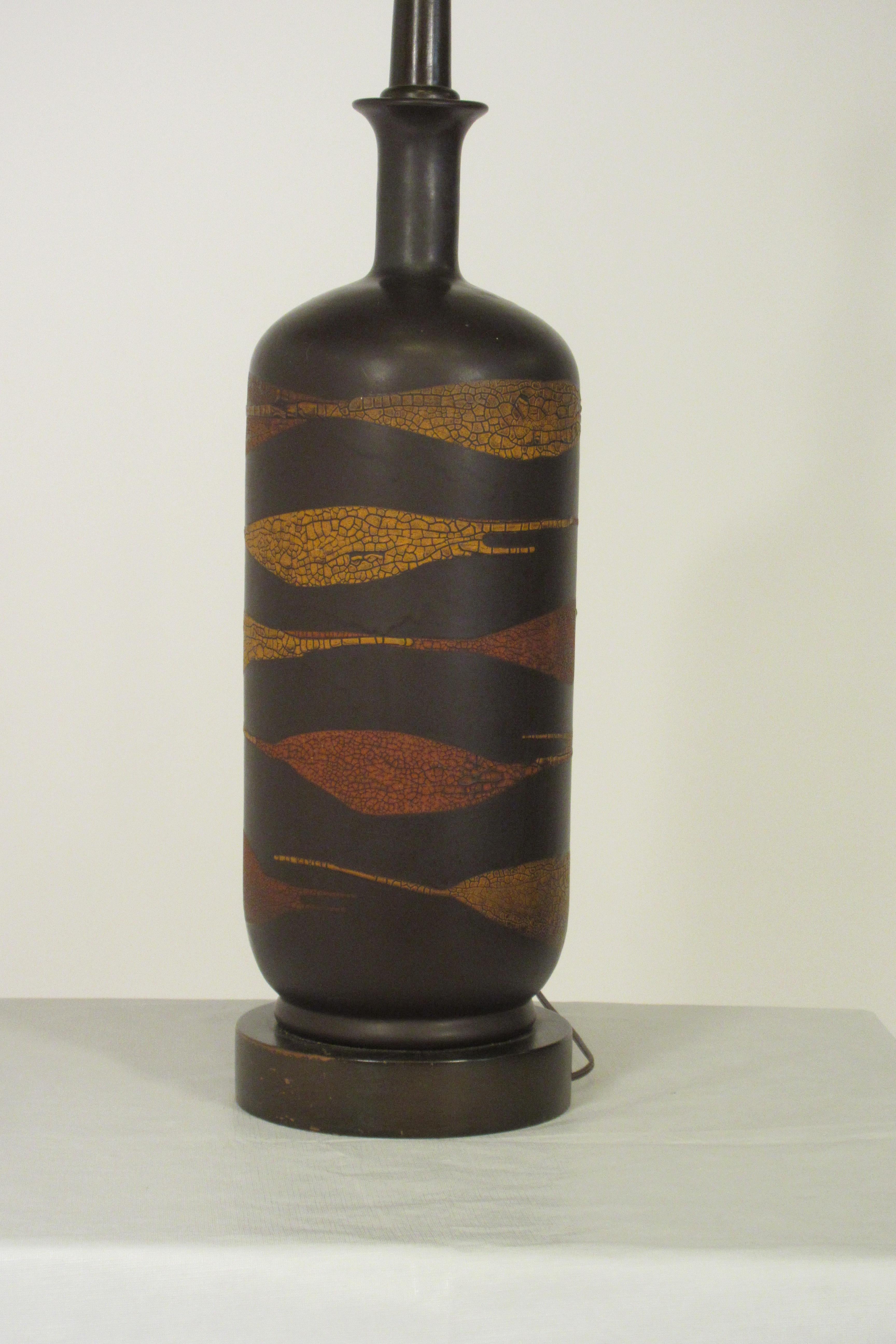 1960s ceramic brown swirl lamp with snake skin pattern on wood base.