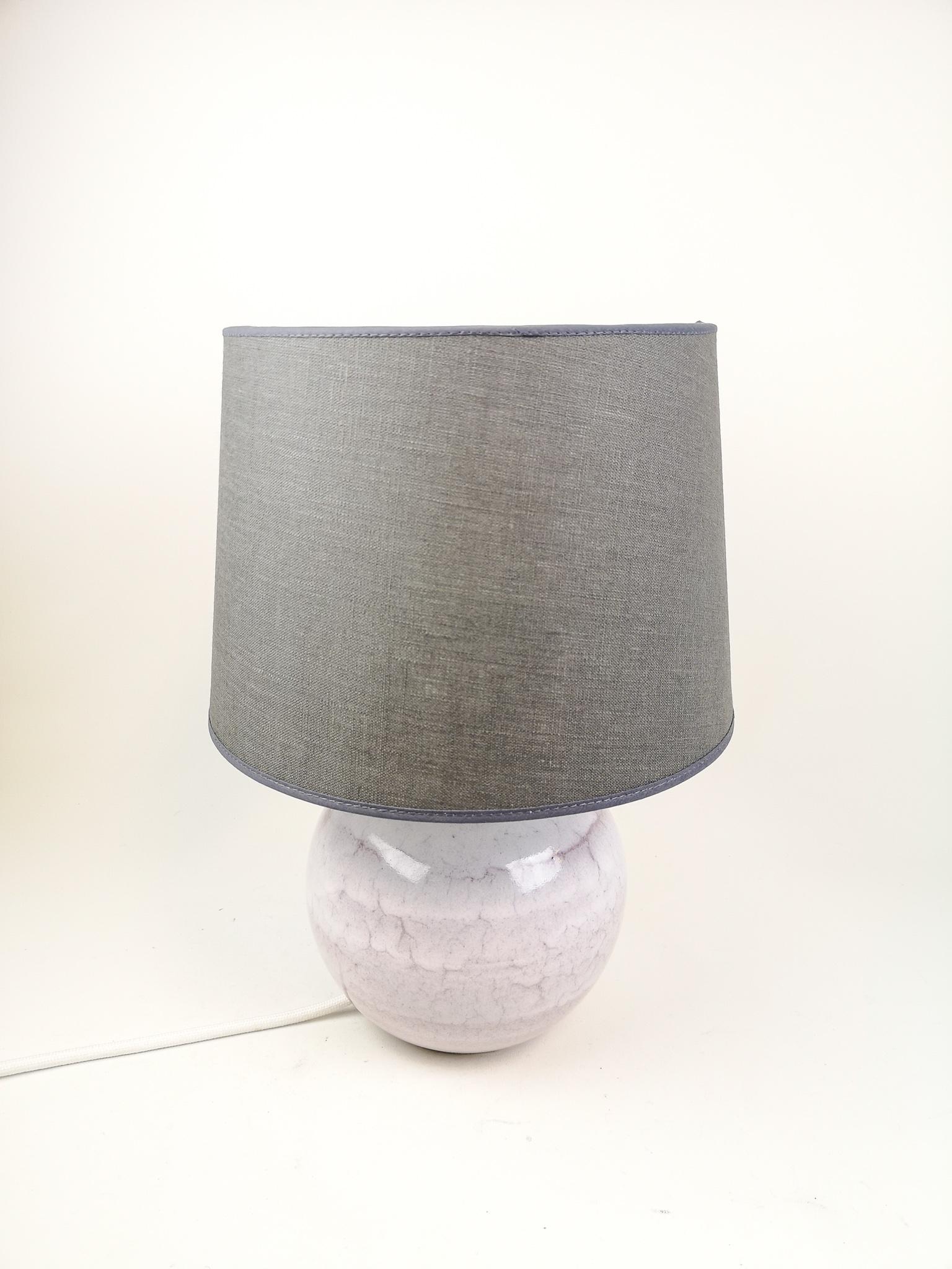 This table lamp was designed by Carl-Harry Stålhane in his studio Designhuset in Lidköping. Its stone wear with a nice pink/white glaze on top. 

In good and working condition. New wiring with a brass holder for the lamp. Not an original shade,