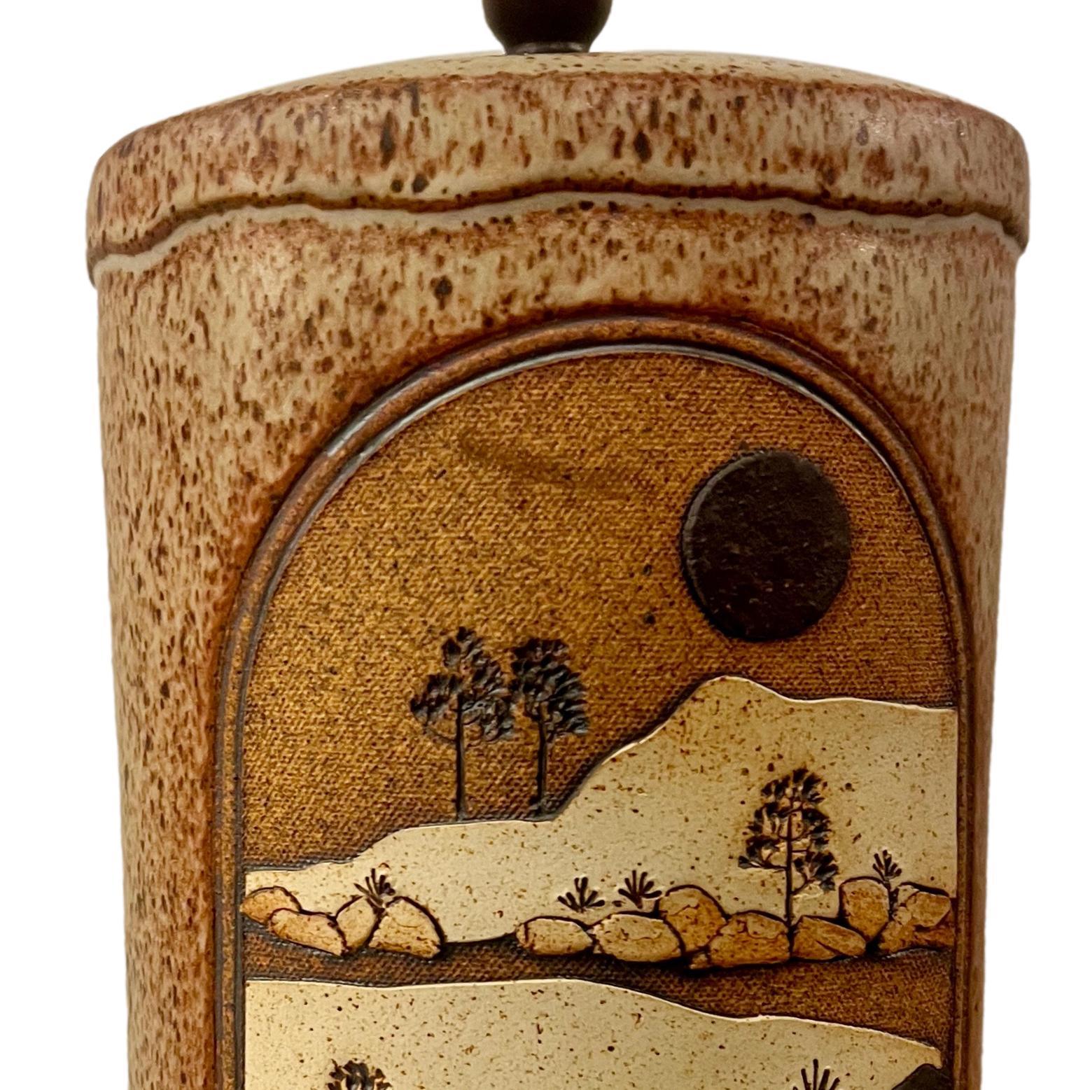 A circa 1950's Amercian ceramic table lamp with a landscape scene.

Measurements:
Height of body: 14