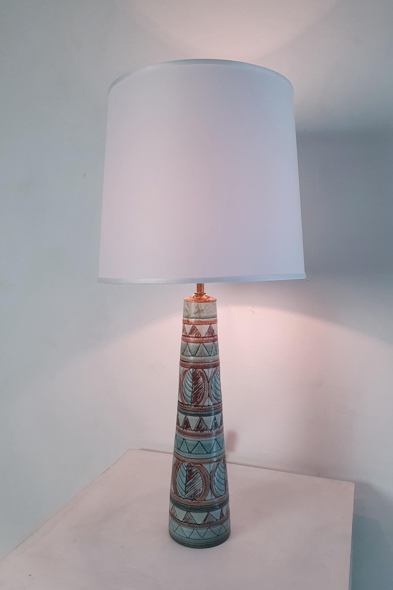 Rare ceramic lamp by Irma Yourstone, Sweden. Decorated with a simplistic design in pastel colors. Comes with a white brand new lamp shade. Marked underneath. Works with E40 light bulbs.