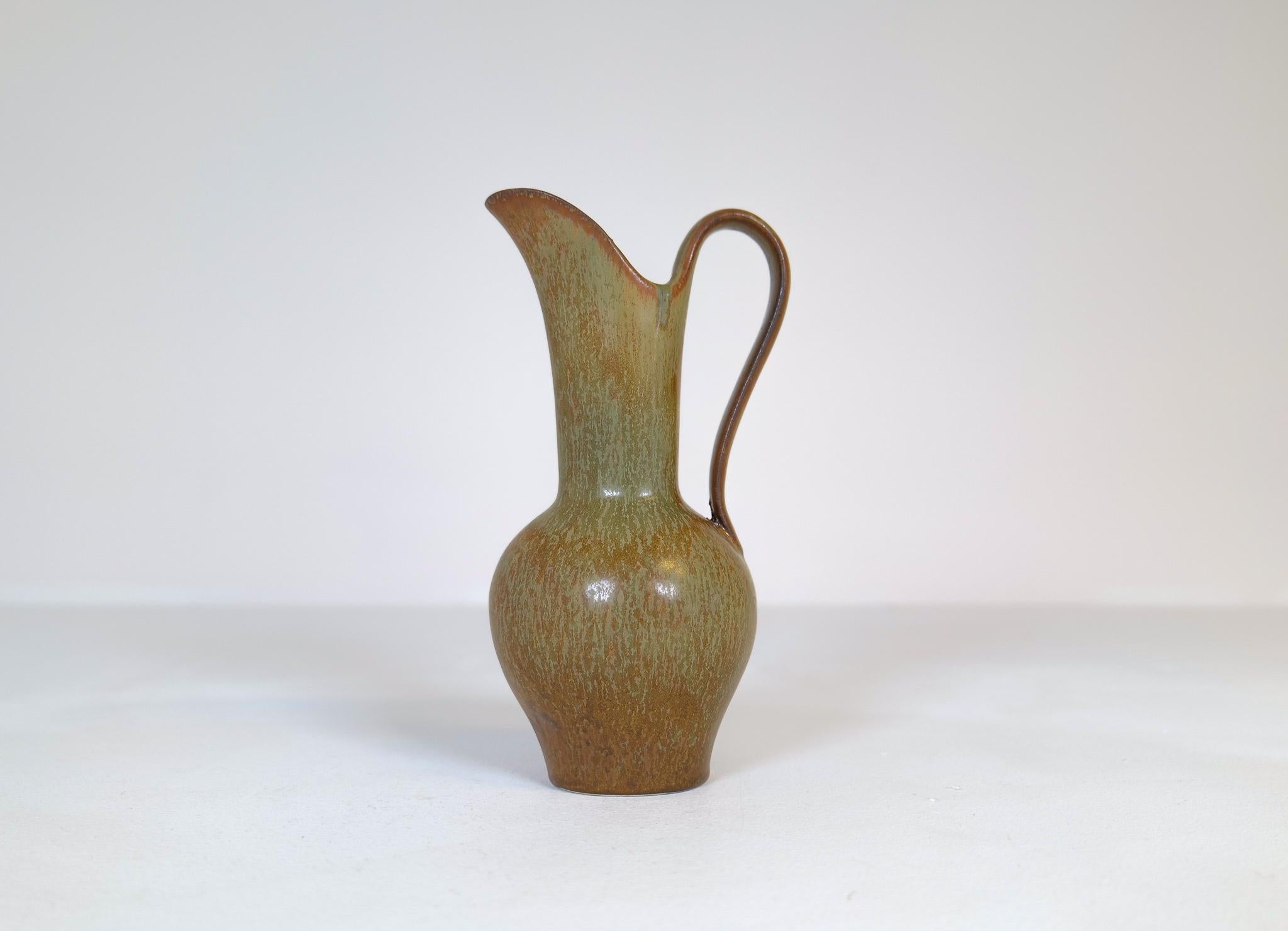 The green/brown glaze is amazing and works wonderful with the shape and form of this vase that’s a not so usual one to come by. 

Very nice condition. 

Dimensions: Height 24 cm, depth 11 cm width 12 cm.
 
 
