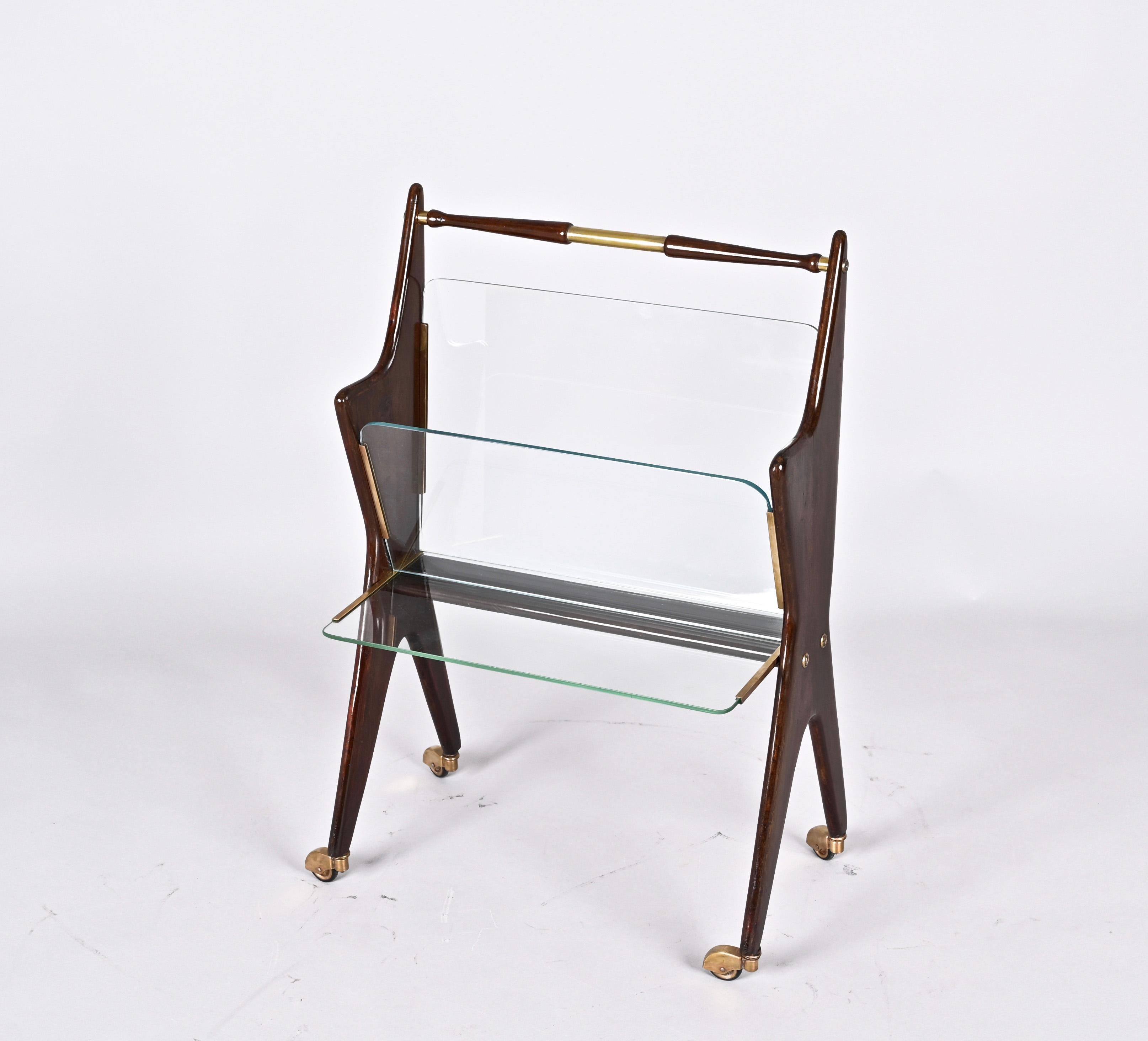 Wonderful Midcentury Magazine Rack in Beechwood and brass.  Cesare Lacca designed this fantastic piece in Italy during the 1950s.

The midcentury aesthetic of this item is just amazing: the structure is made of beech wood with 3 crystal glass on the