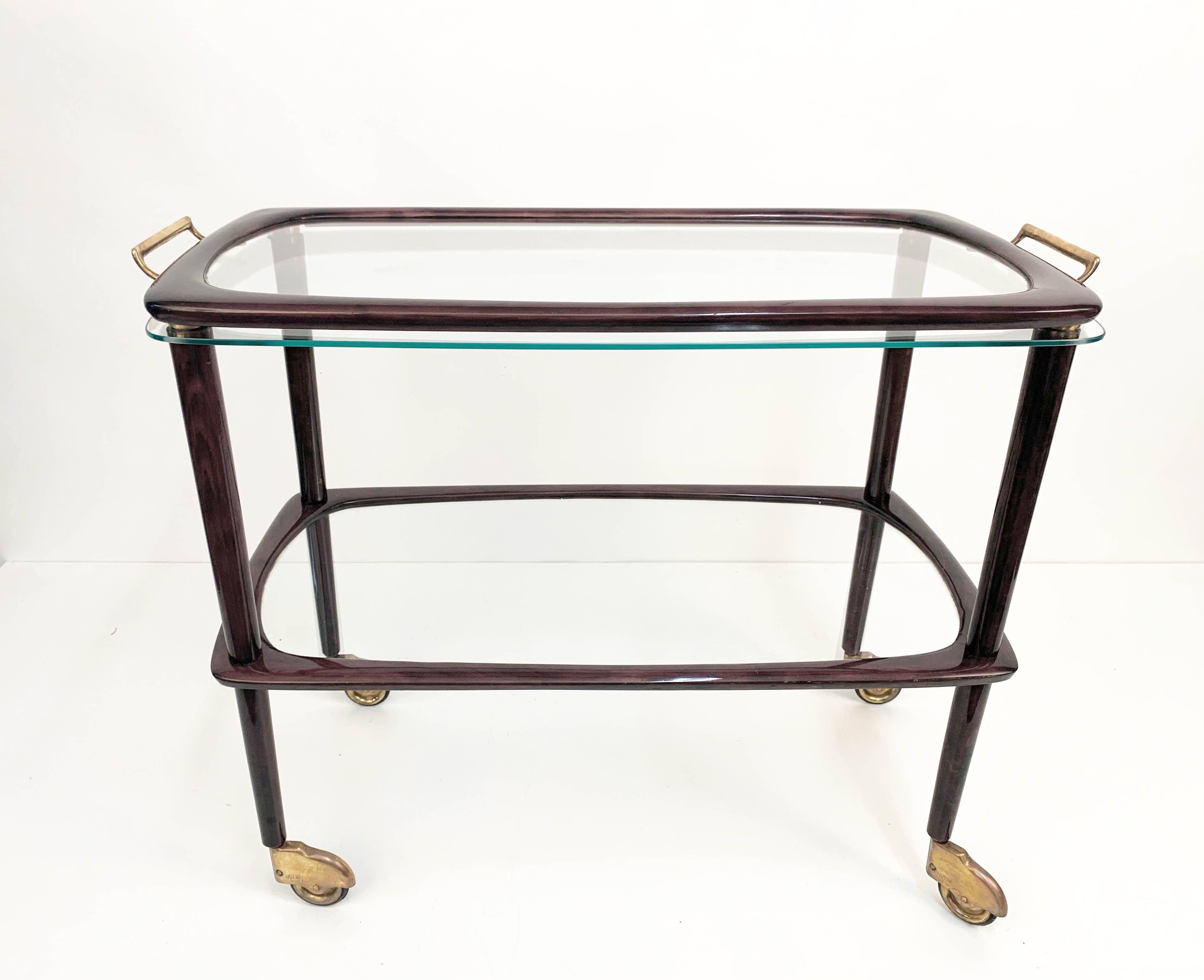Wonderful Italian wood trolley with glass and brass finishes. It has a removable serving tray with brass and chrome finishes.

This 1950s production is attributed to Cesare Lacca, has wonderful rounded lines and materials plus amazing brass